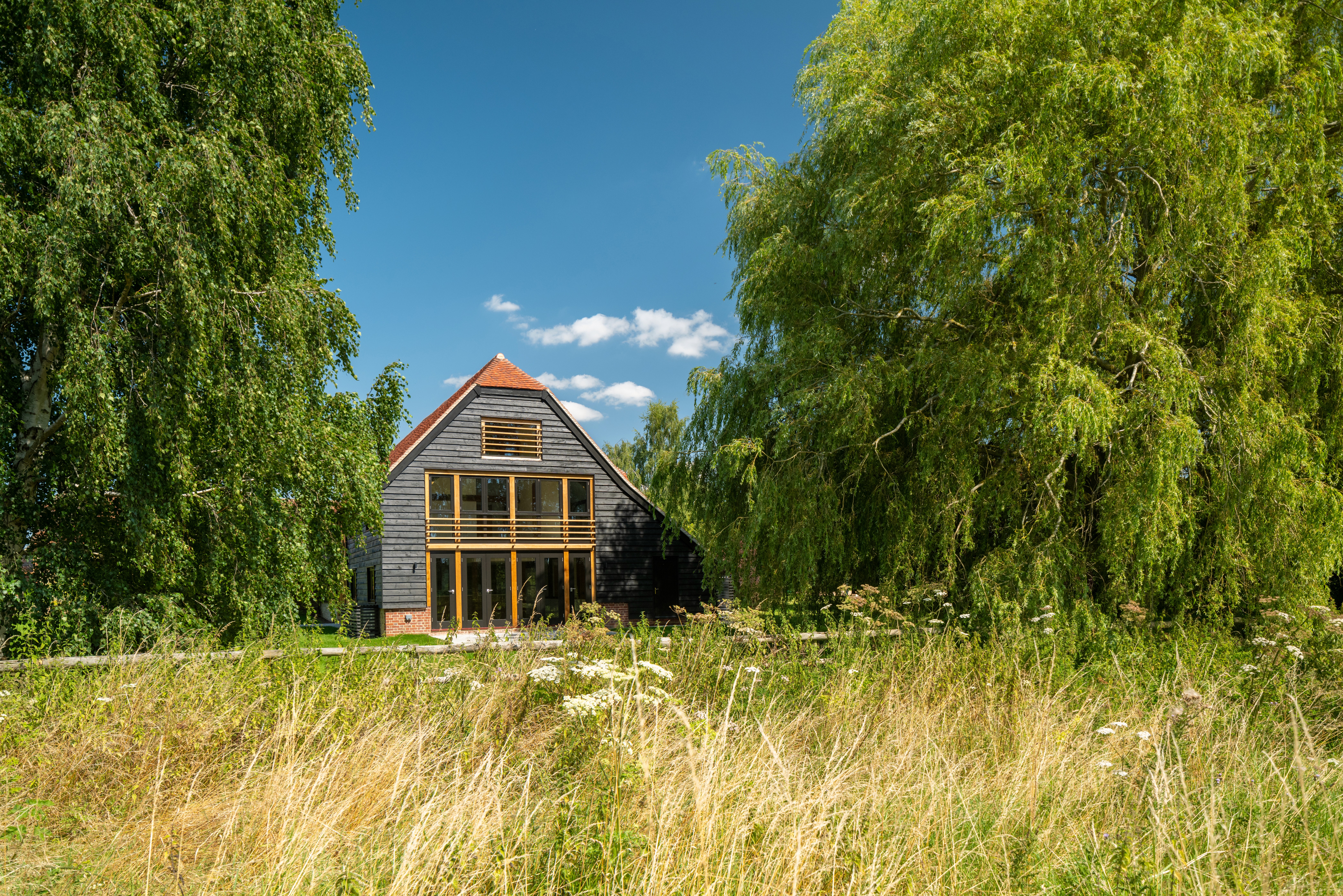 Contemporary rear extension with sedum roof and timber cladding in Gamlingay 1920s house refurbishment
