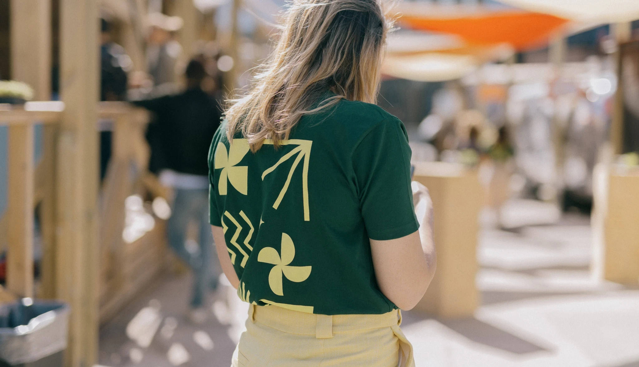 A female festival volunteer wearing the Katapult Future Fest t-shirt.