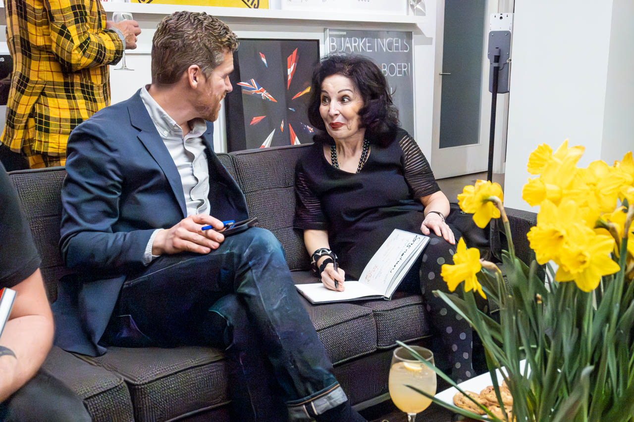 two people at a cocktail party looking at the camera