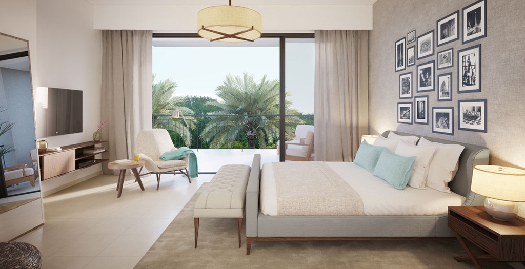 A spacious bedroom featuring a large bed and a wide window allowing natural light to fill the room.