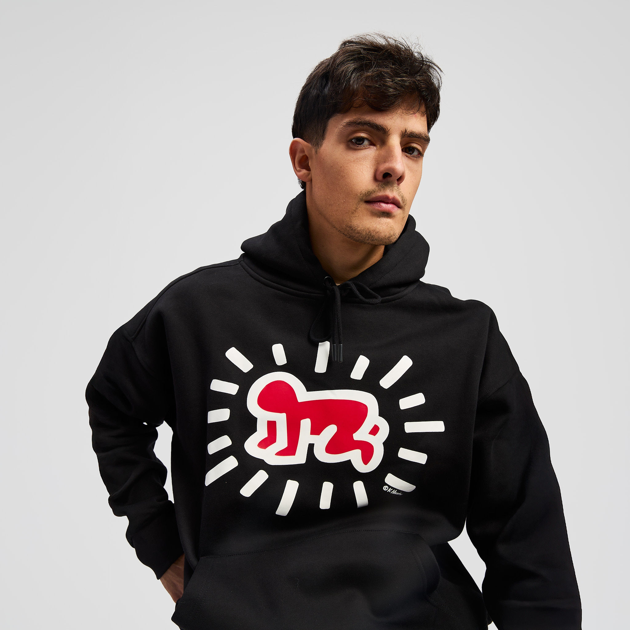 Young woman with dark hair and bangs, wearing red.