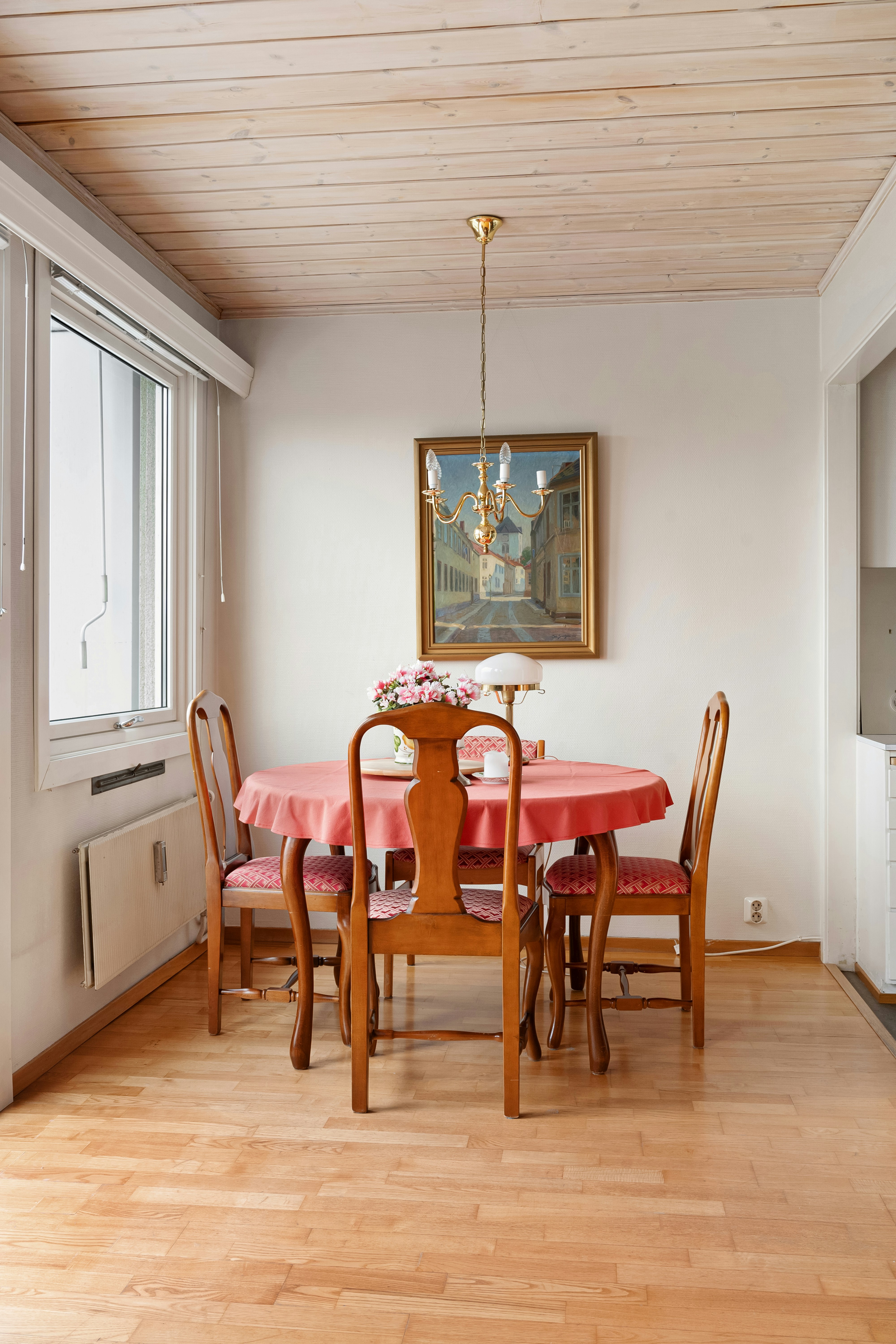 A dining room with a table and chairs
