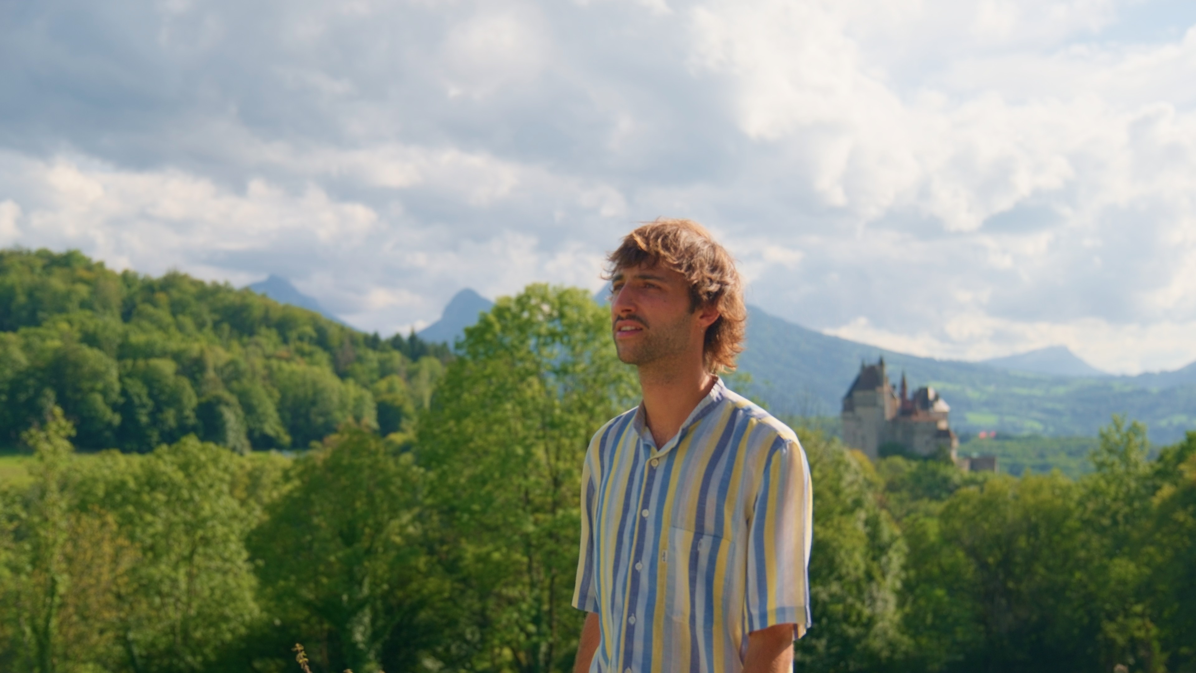 Sand dunes meet the ocean under a clear blue sky.