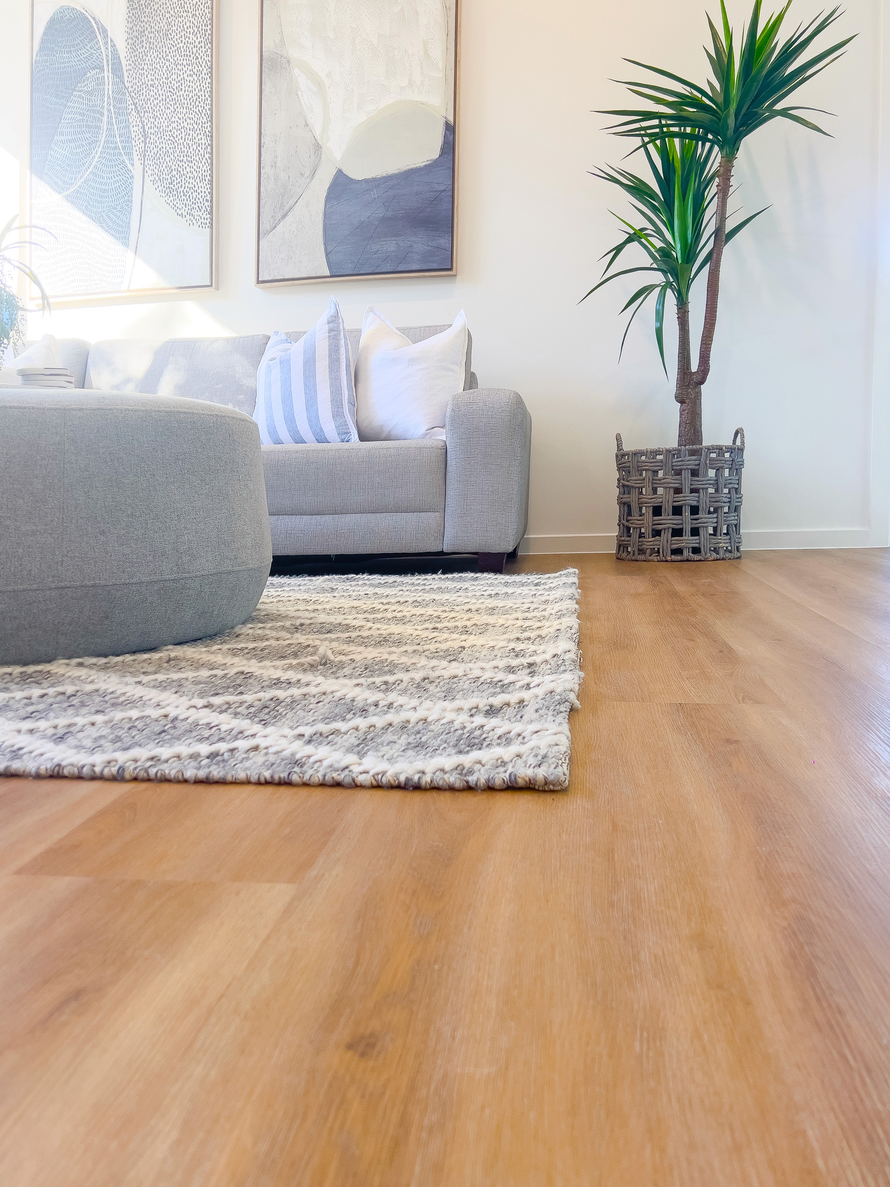 Sunlit Brisbane living room with water-resistant hybrid flooring that stays easy to clean and calm under everyday wear.