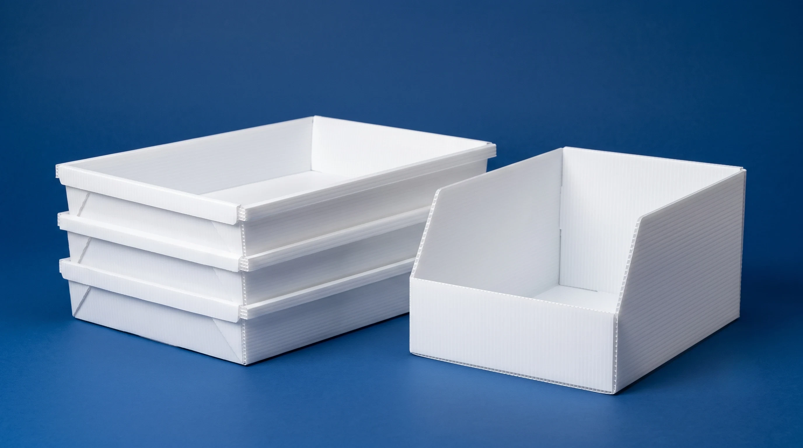 Stack of white PP corrugated trays with an open-front PP storage bin