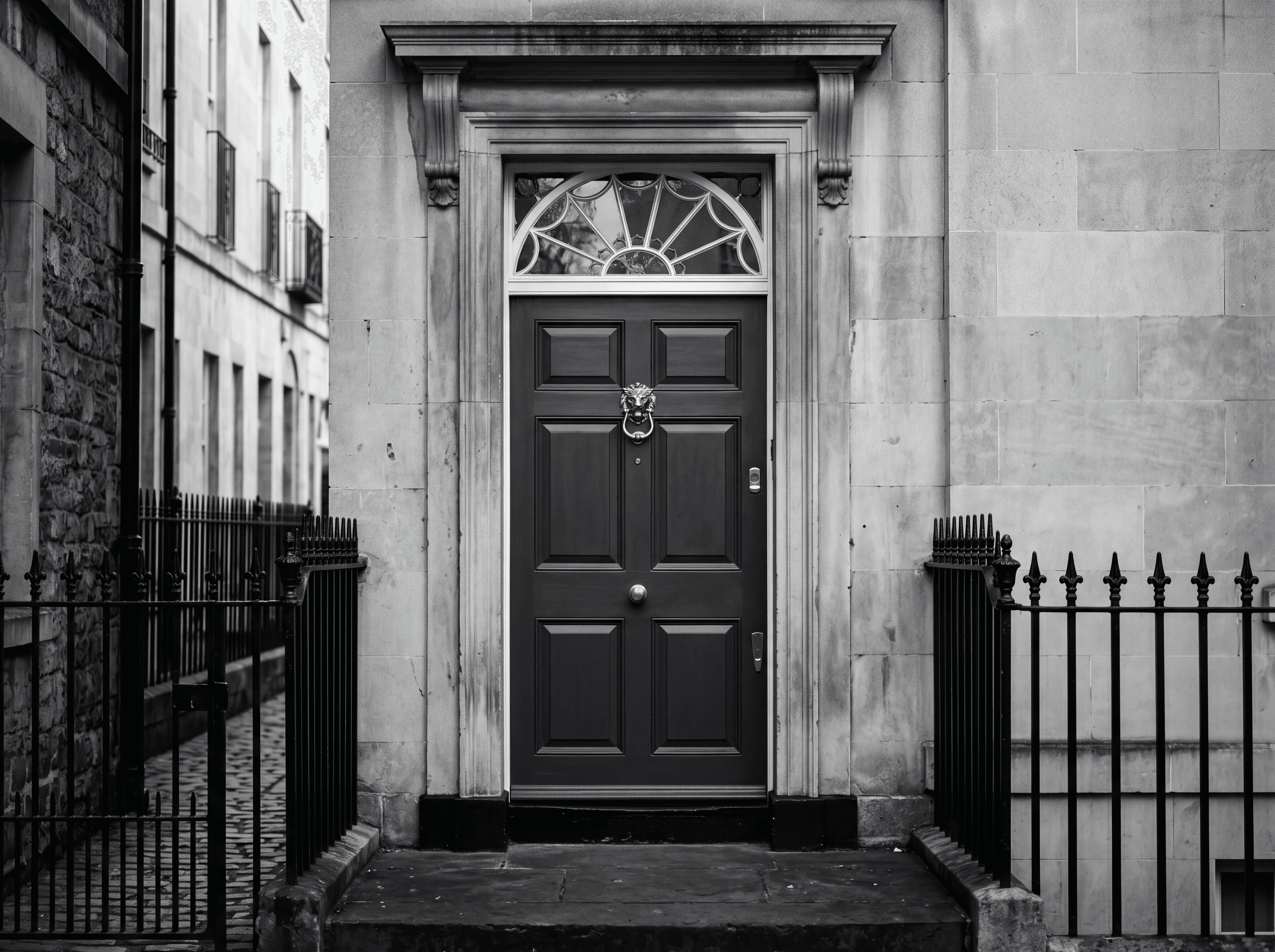 A discreet Prime Central London principal doorway in black and white, representing off-market property sourcing through long-standing private relationships.