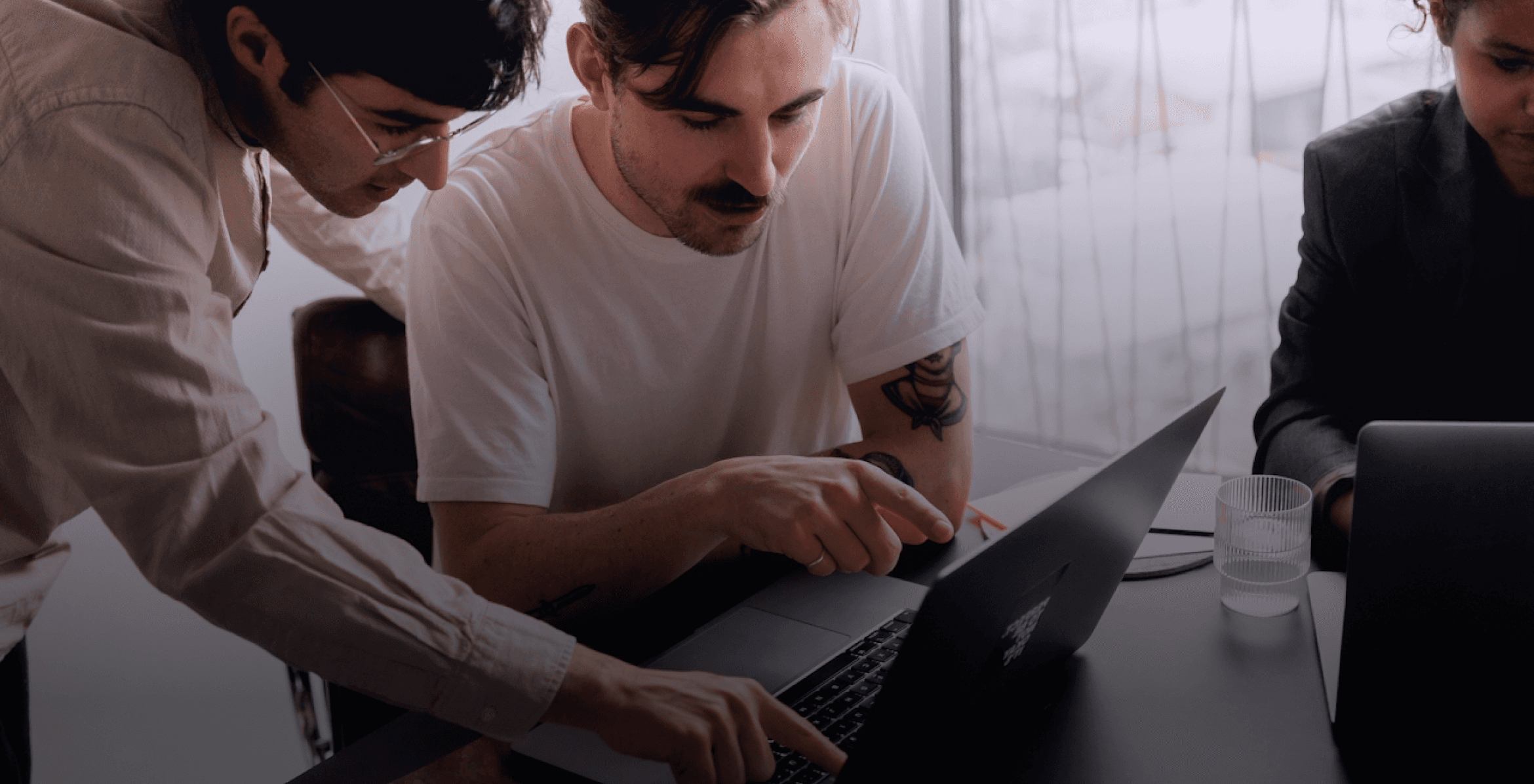 People looking at the laptop together
