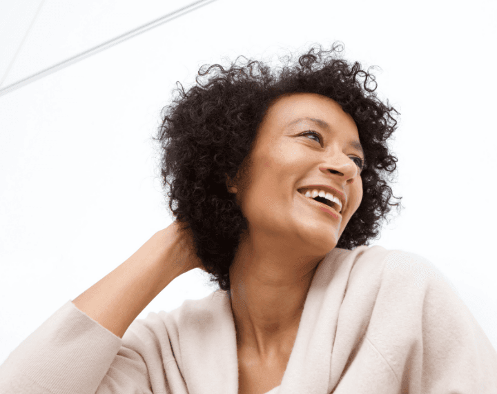 Smiling woman, representing menopause benefits available with health insurance