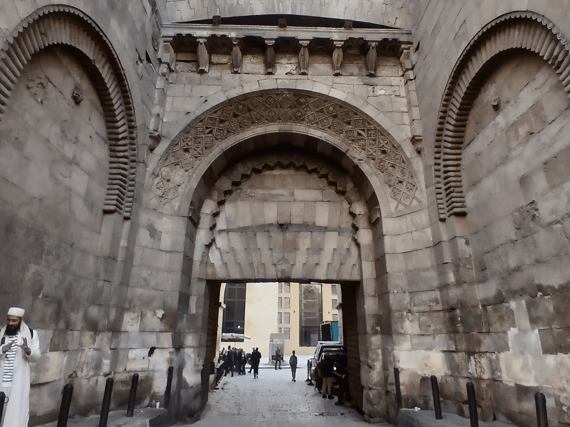 An image of one of a large gate, one of Fatimi Cairo. The gate is decorated with carvings and symbols from Fatimi times.