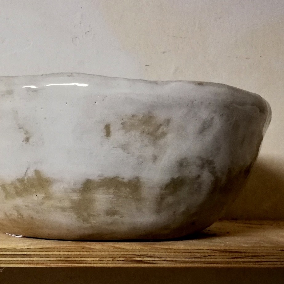 Man standing with hands in prayer position and eyes closed