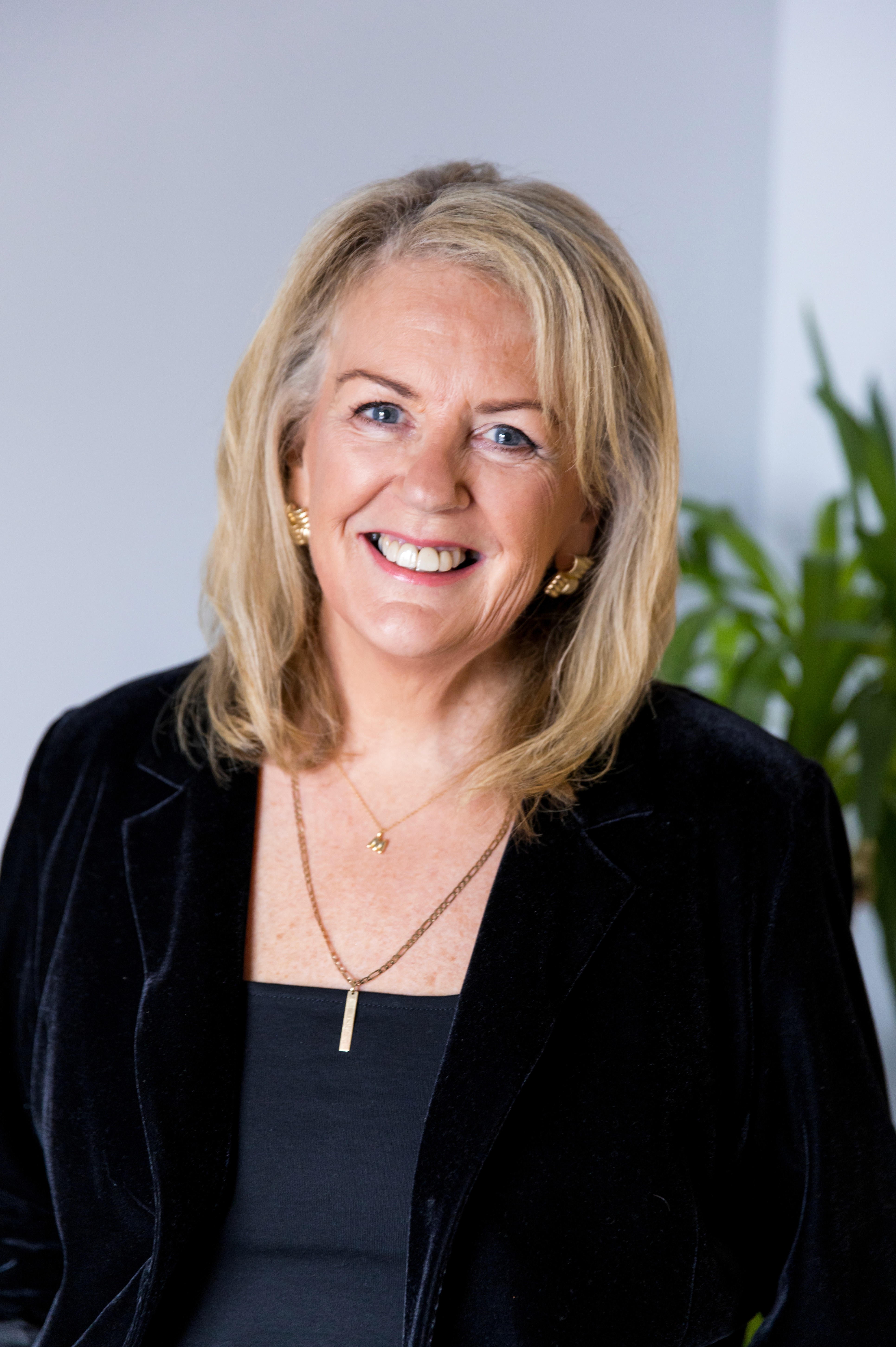 professional headshot of muriel with a black fleece