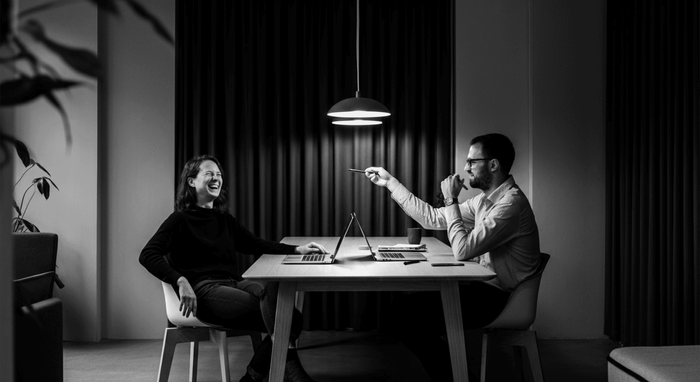 Men and women are sitting at a table.