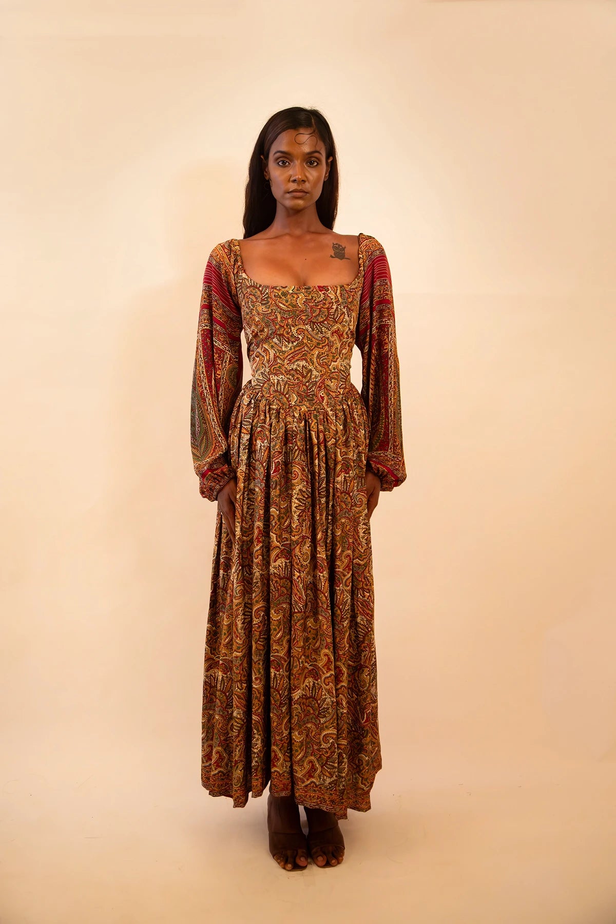 IRA our one of a kind, brown printed maxi dress. the garment comprises of puff sleeve and a back tie 