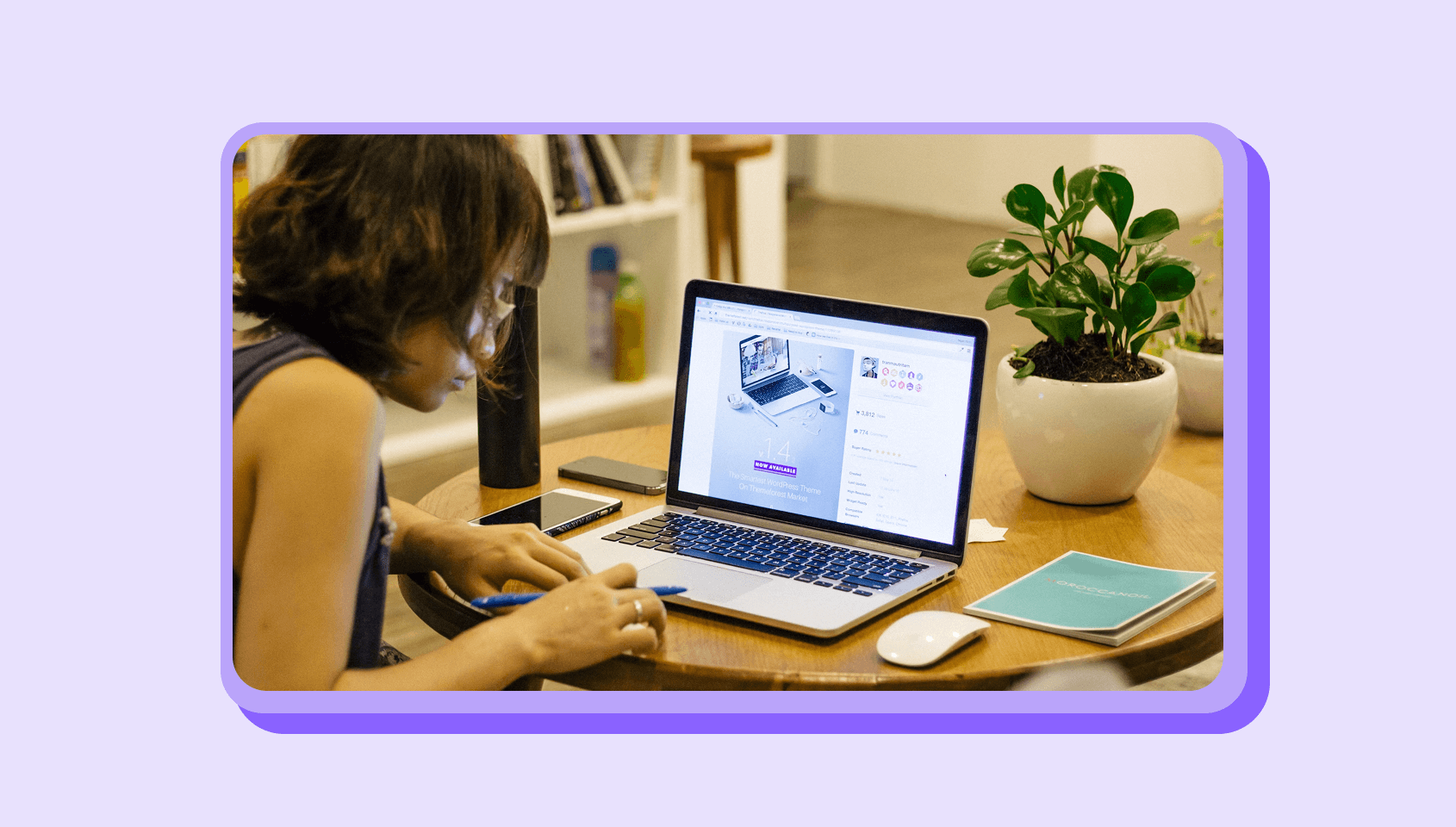 A woman is taking notes by looking at her laptop.