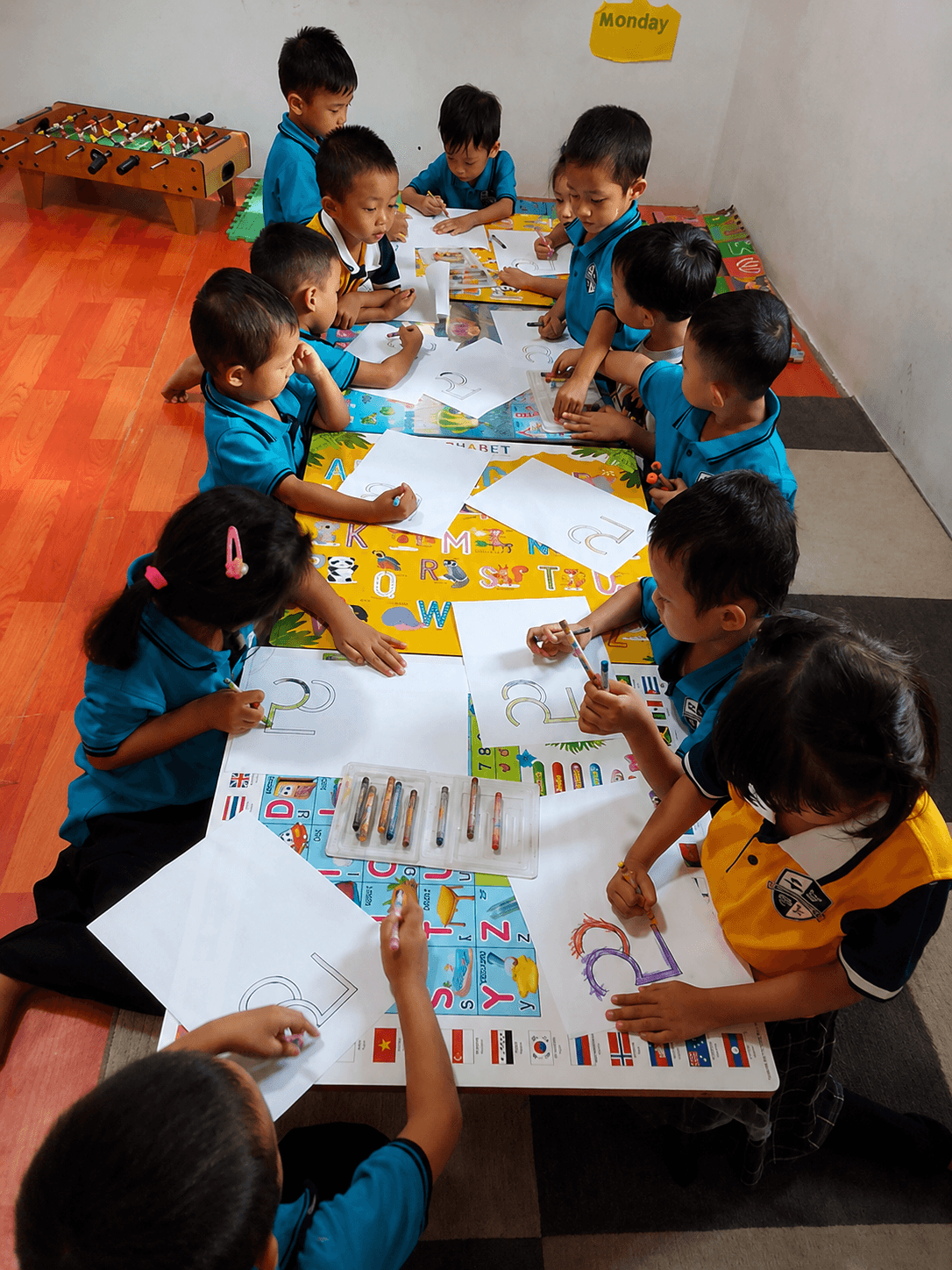 Elementary years students at Elpis International School working together on a coloring activity in Yangon, Myanmar