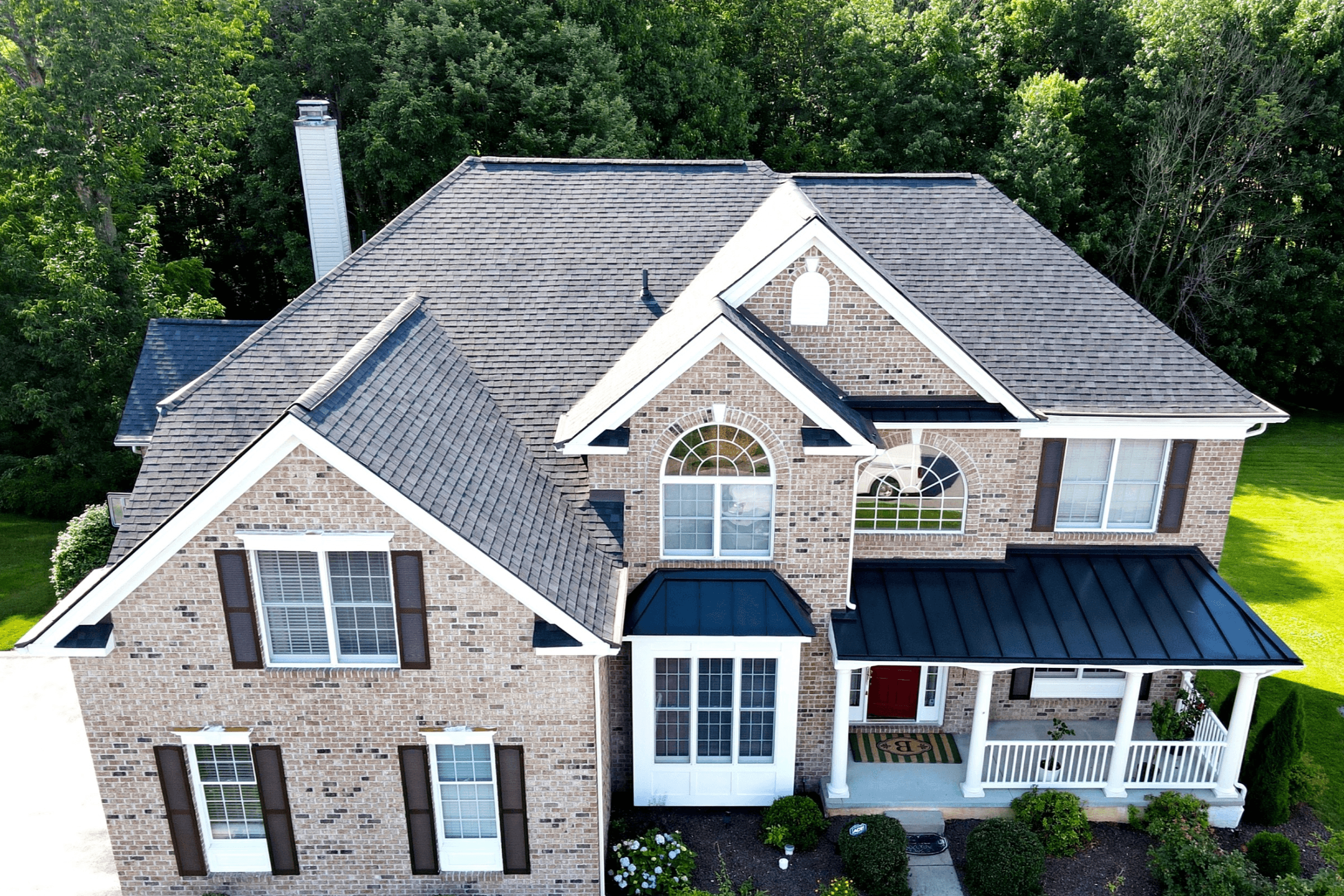 New metal and architectural shingle roof installed on roof in Kansas City