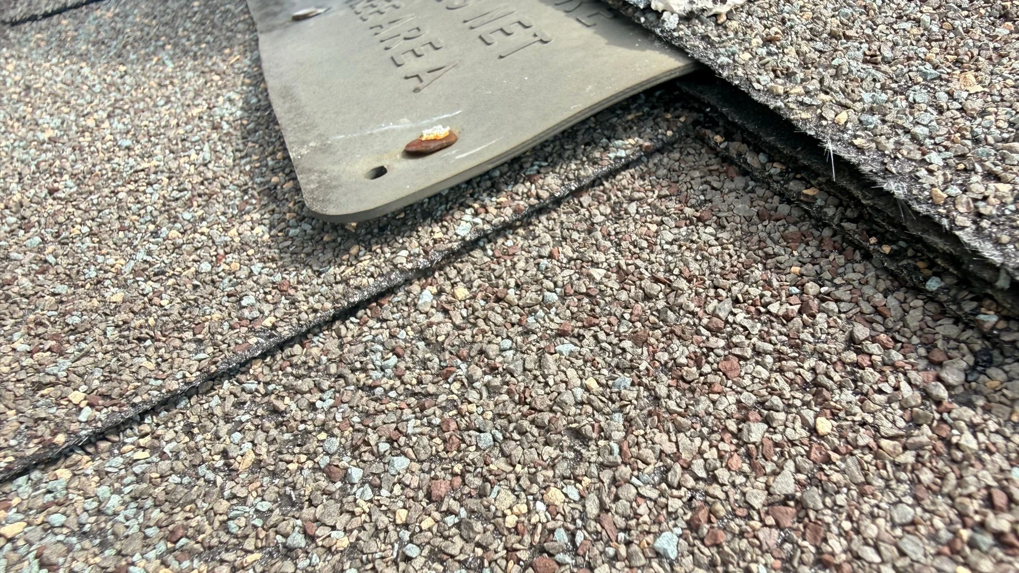 Before repair: ridge-cap and vent flashing repairs in San Antonio, Texas.