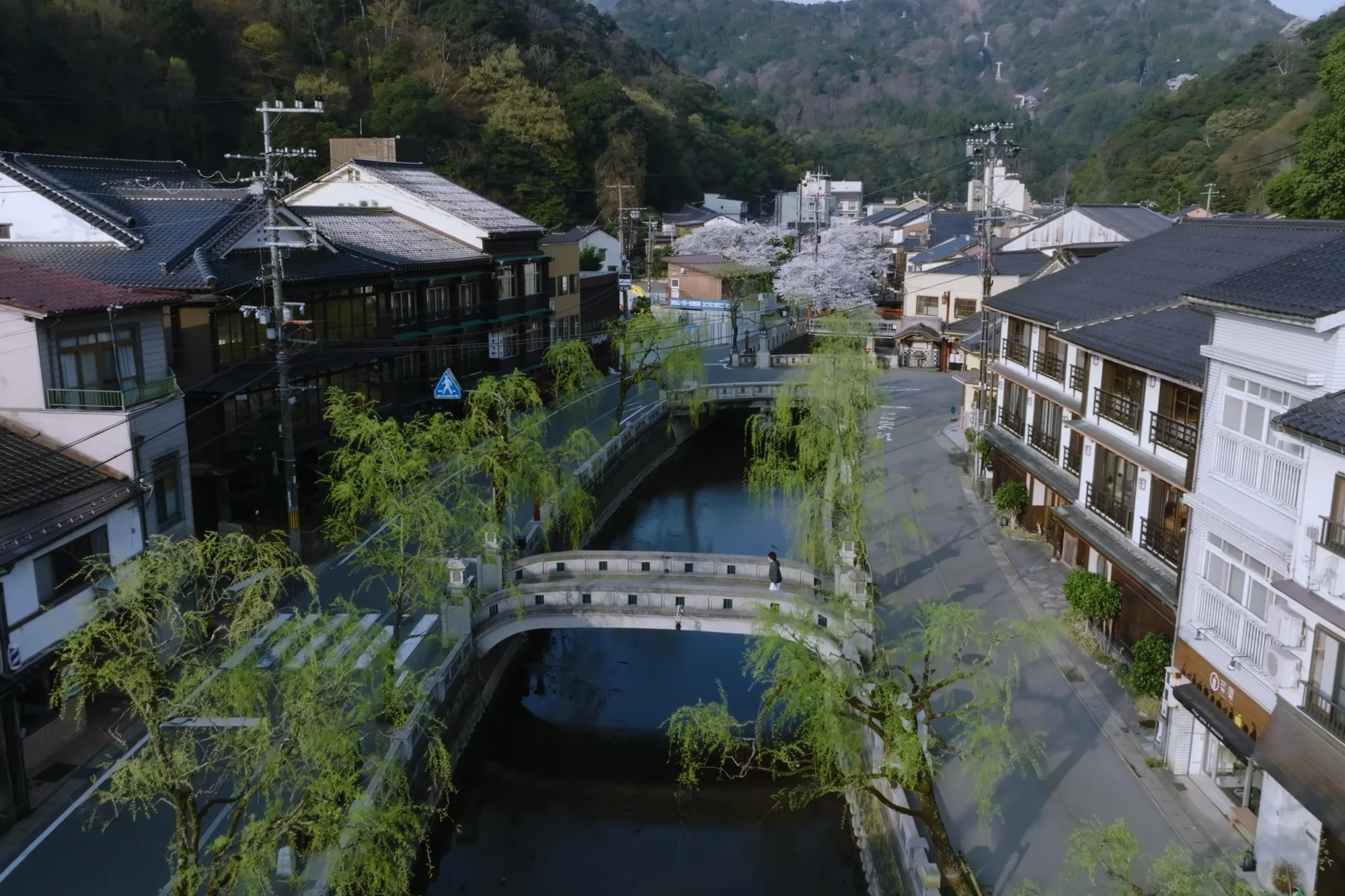 Elevated view along the Kinosaki canal with inns on both banks.
