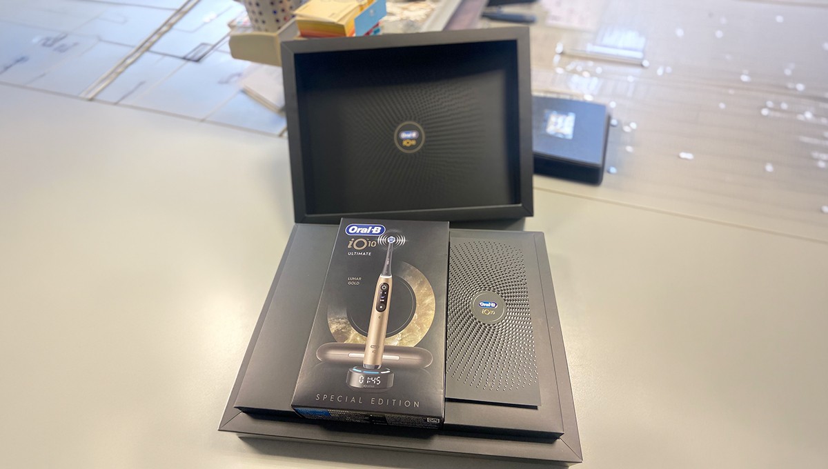 Family standing in a lush green field with tractor.