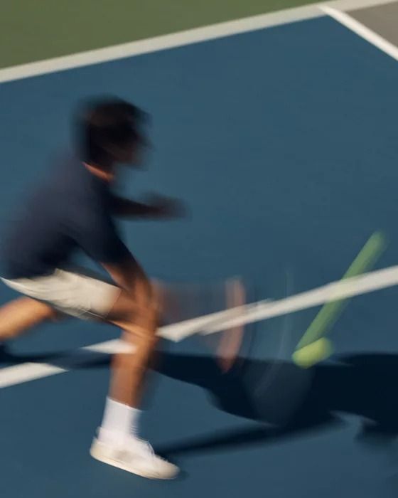 A woman hitting a tennis ball with a racquet