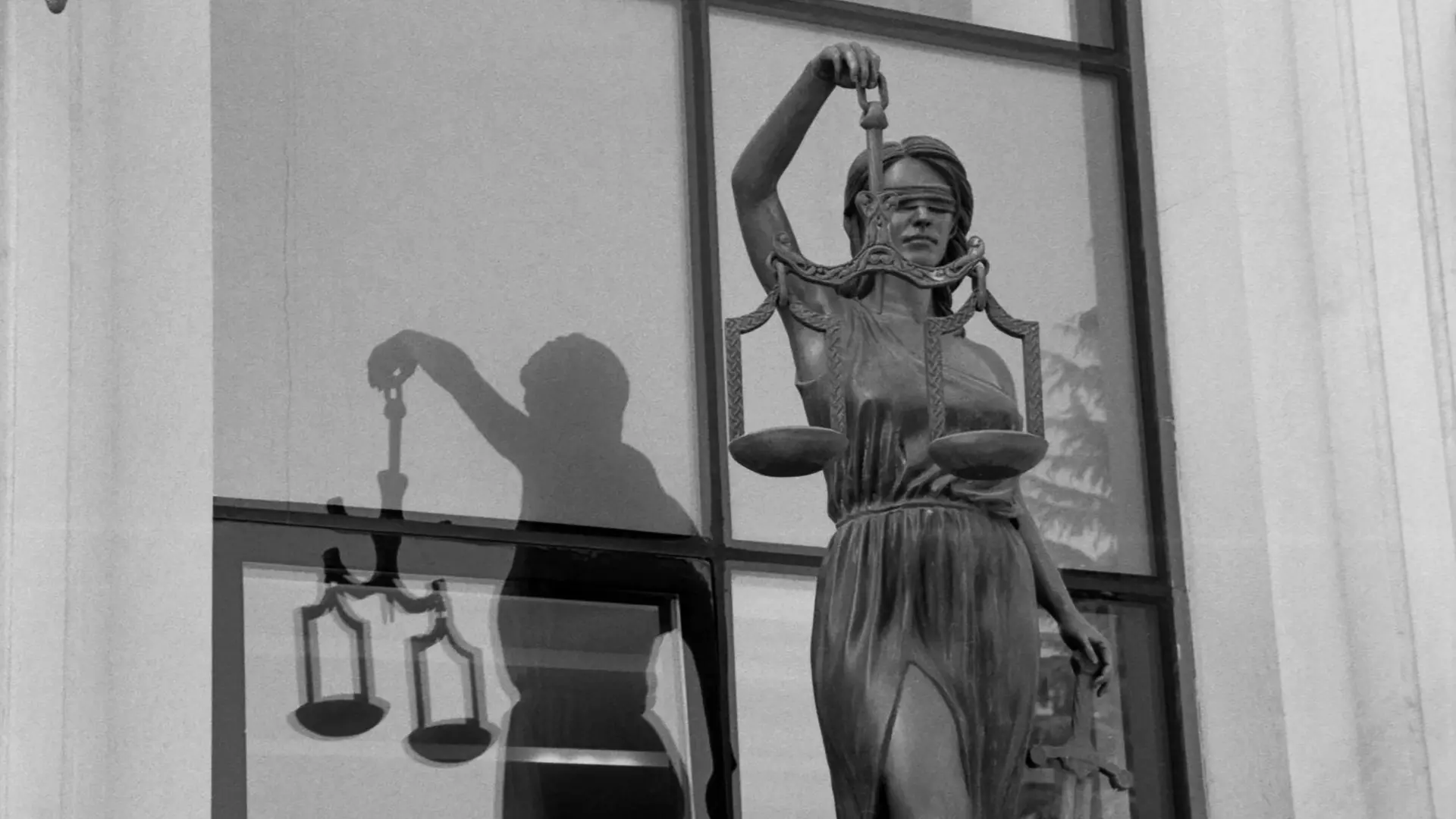 a photo of an empty well lit court room with warm and bright lighting taken from the back of the room that has a wooden theme.