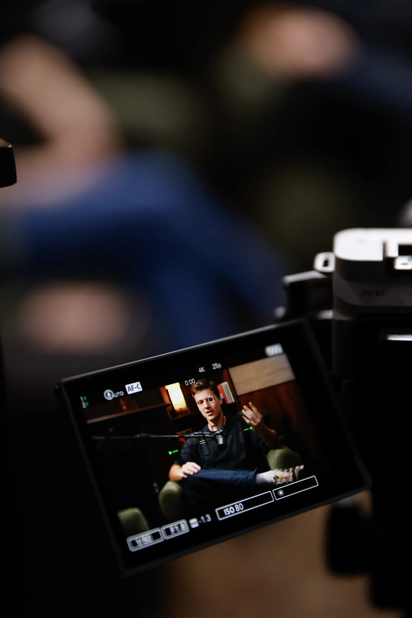 A camera monitor showing a guest being filmed on the ASPEN set
