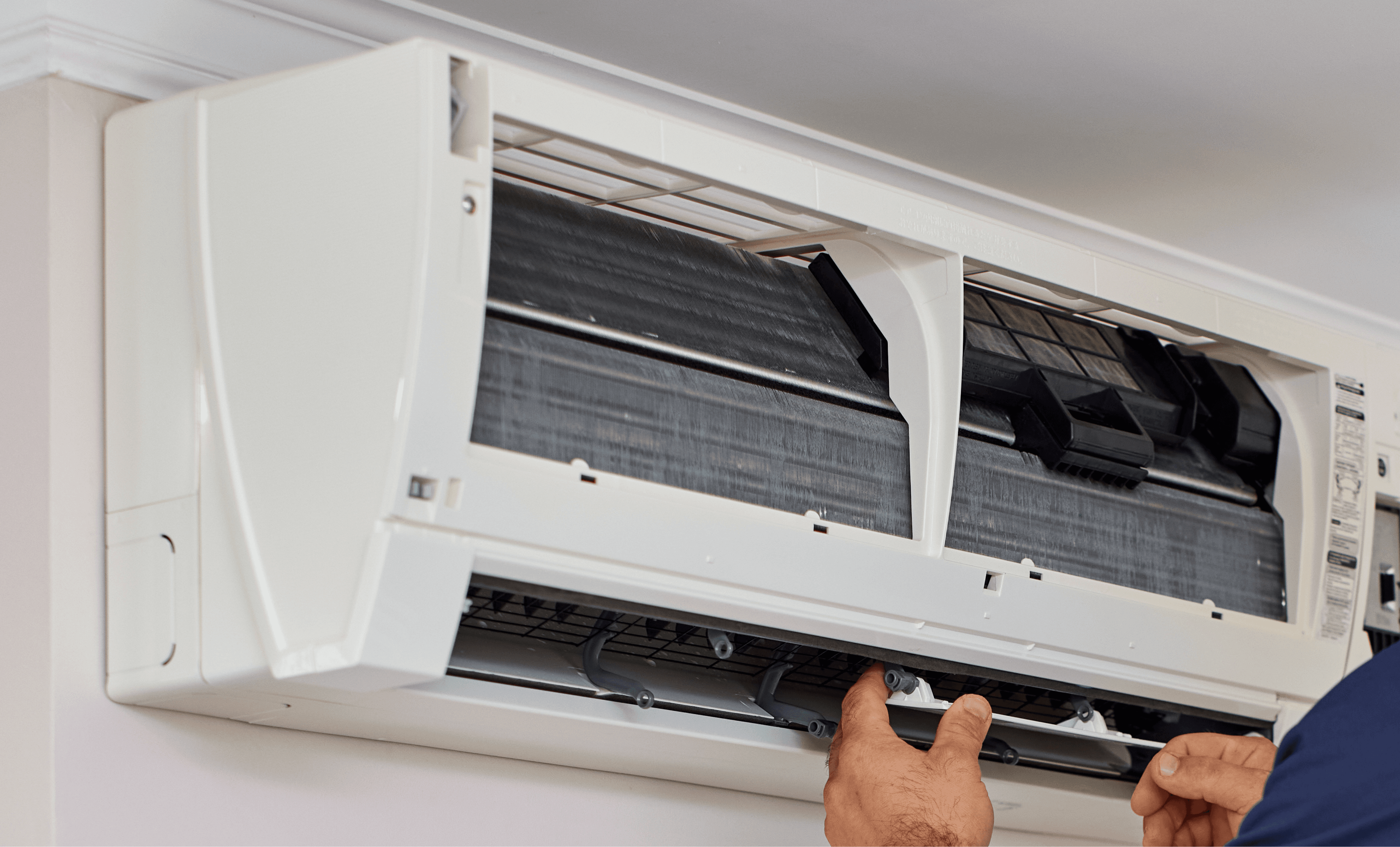 Technician servicing air conditioning unit