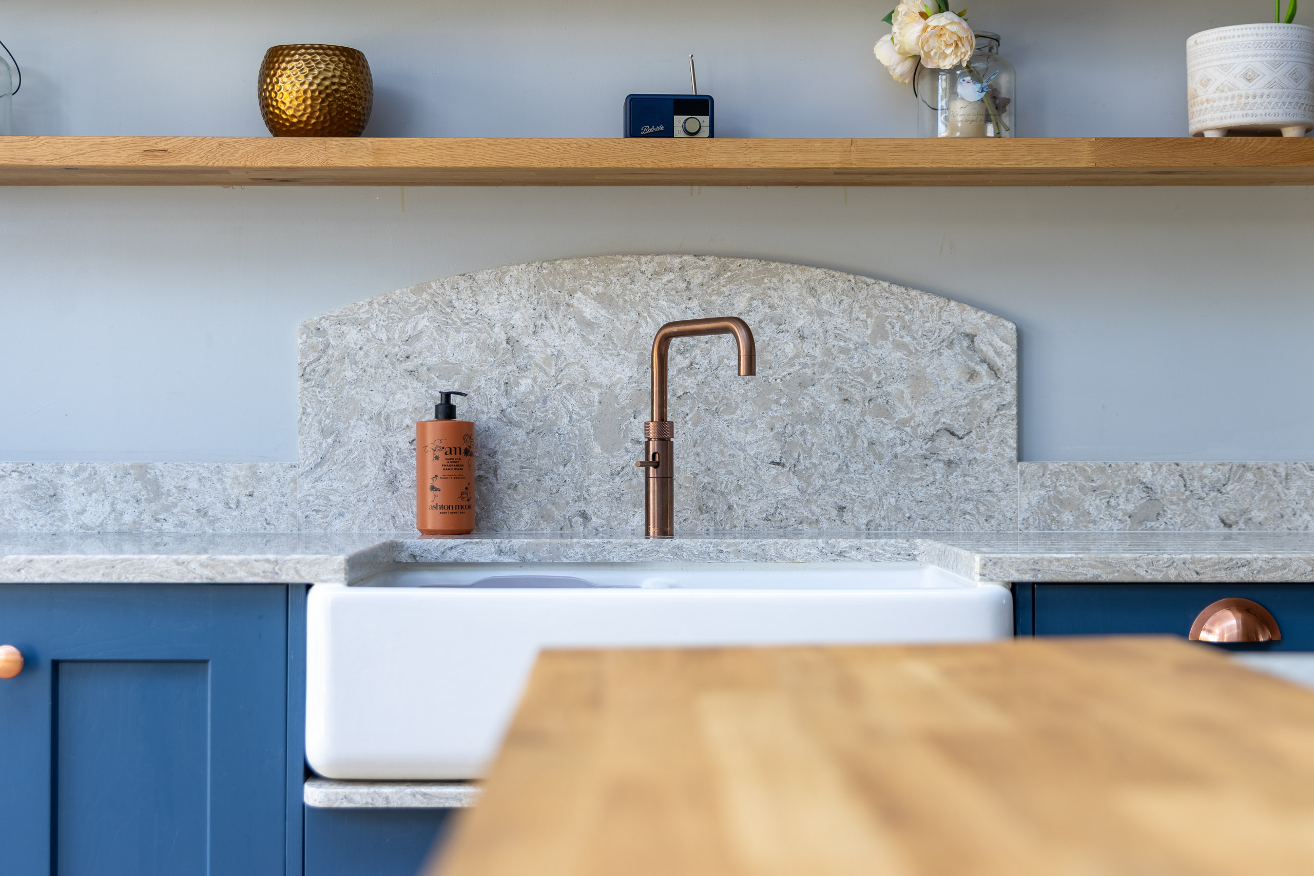 belfast sink with quooker boiling tap in blue shaker kitchen and quartz splashback
