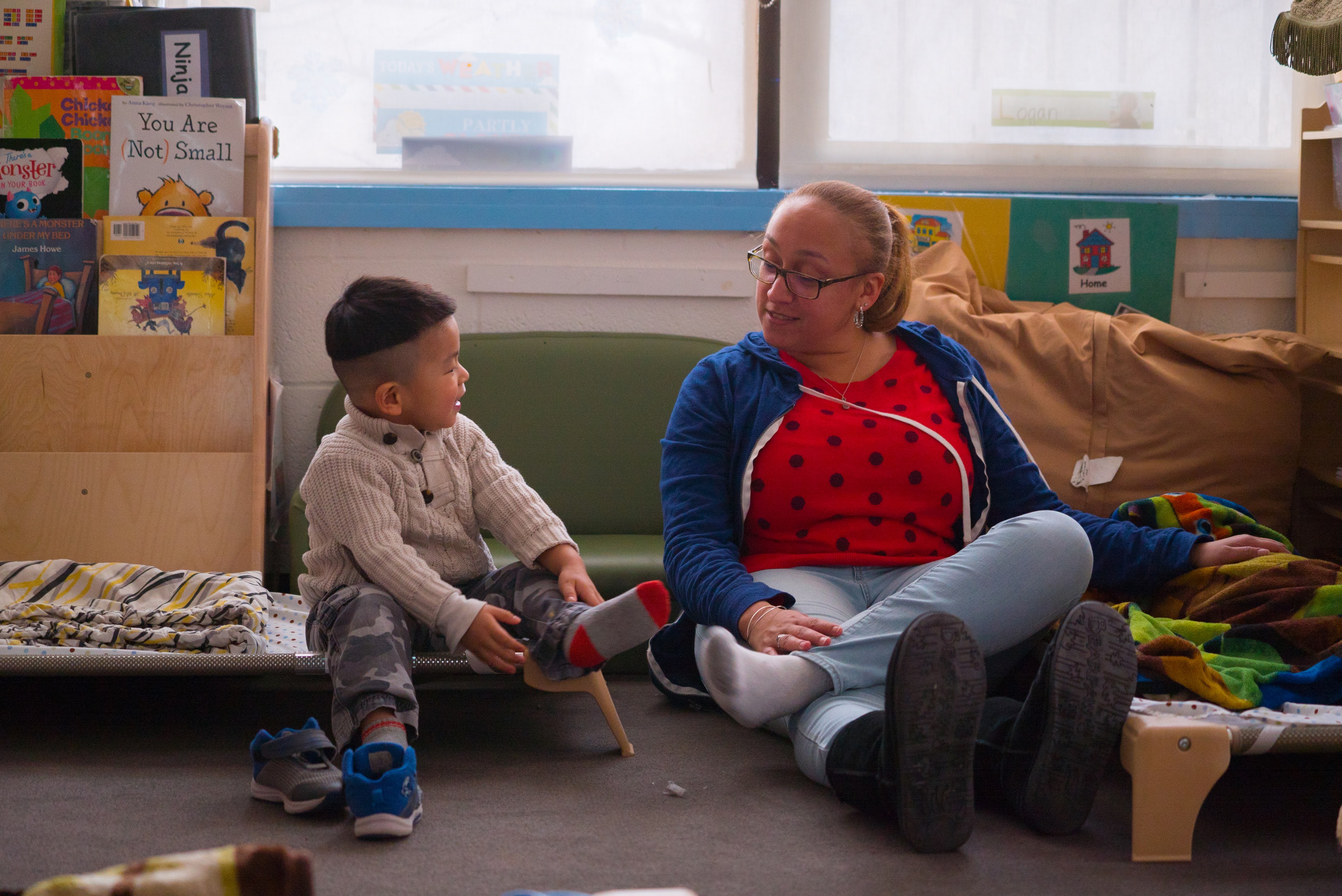 A teacher and student sit next to each other.