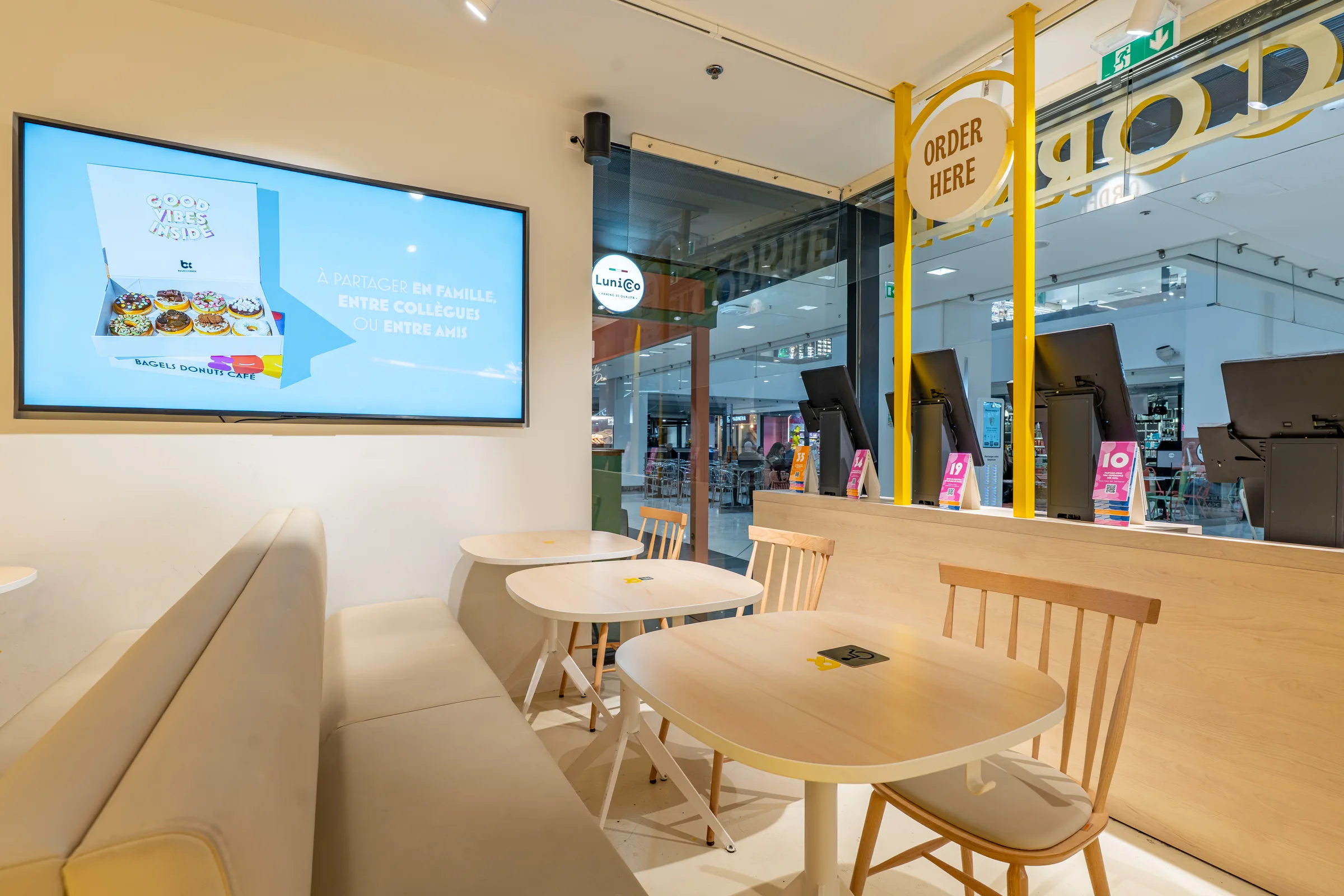 Tables and ordering screen at Bagel Corner Nice — Nice, France. Photography by Yunes Calore.