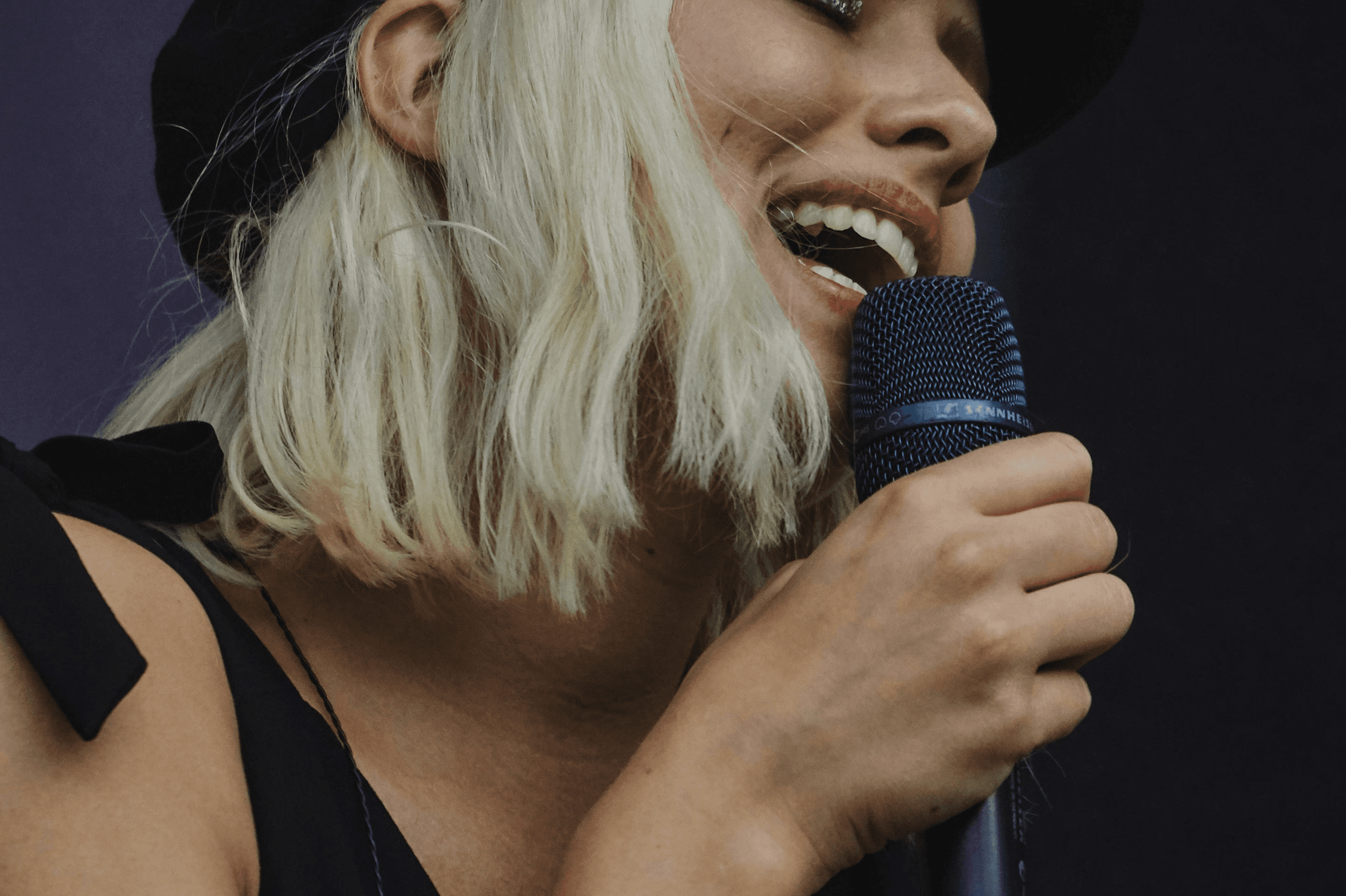 A woman singing into a mic