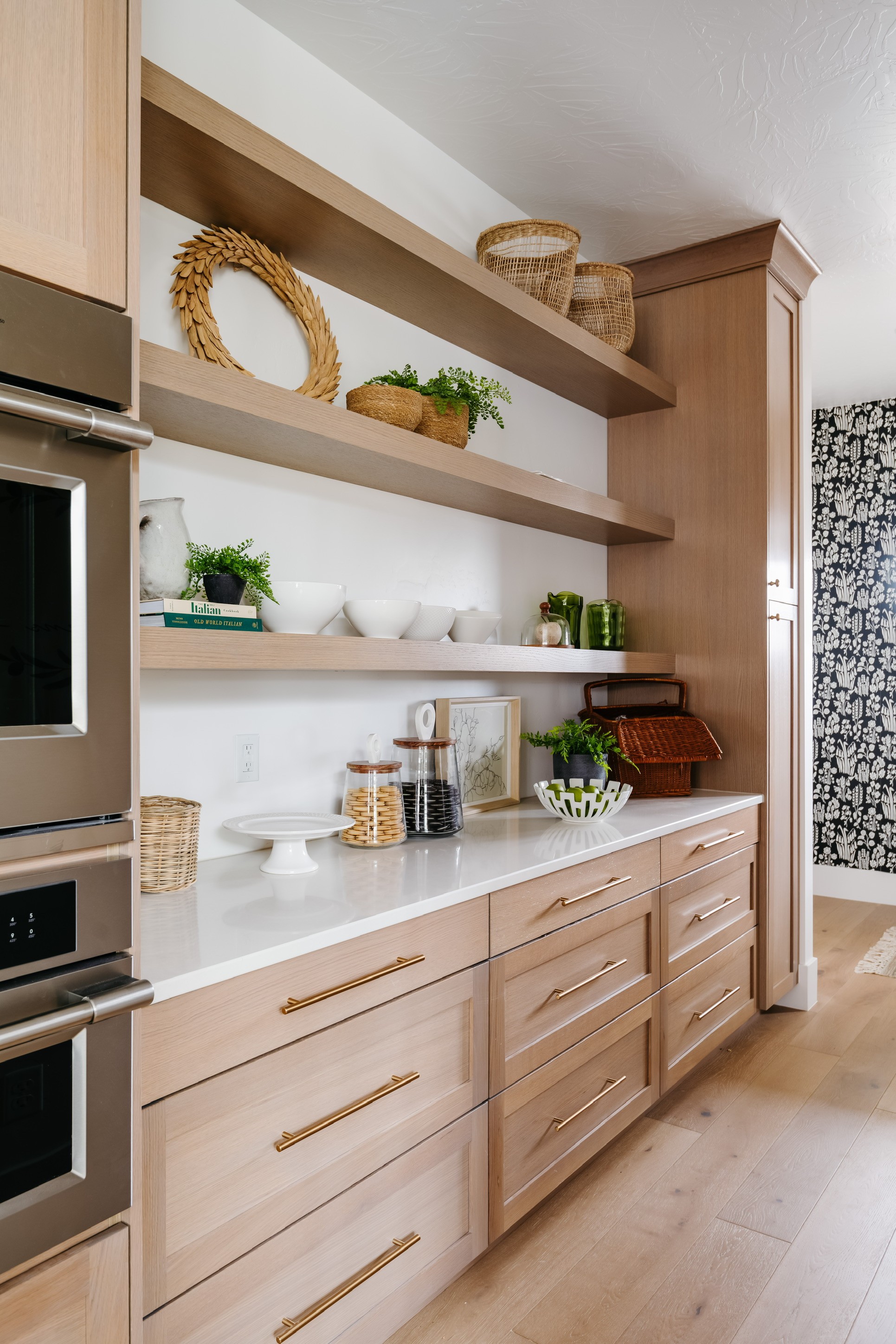 Modern kitchen in Hurricane, Utah with light oak cabinets and white countertops.