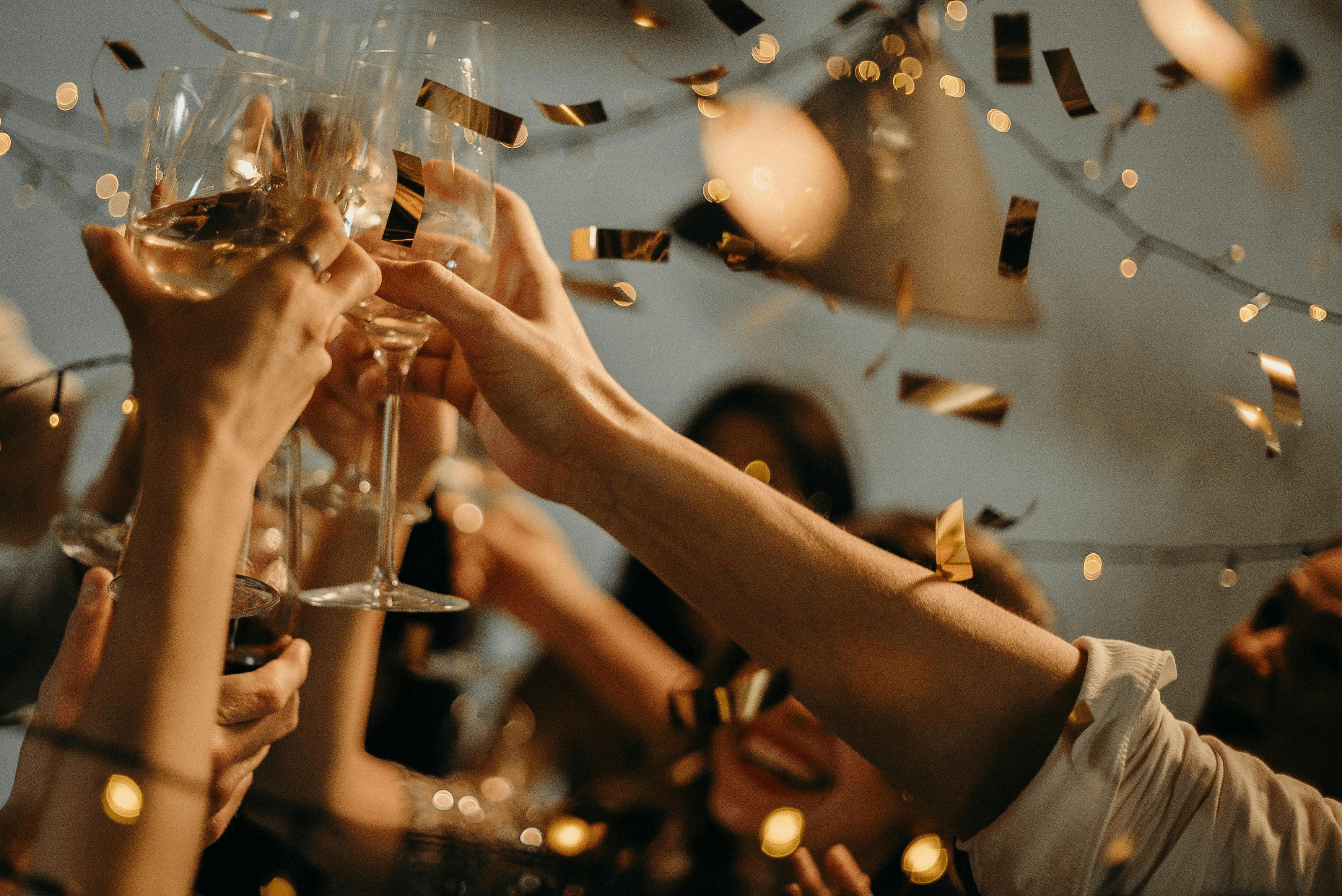 raising champagne glasses to cheers