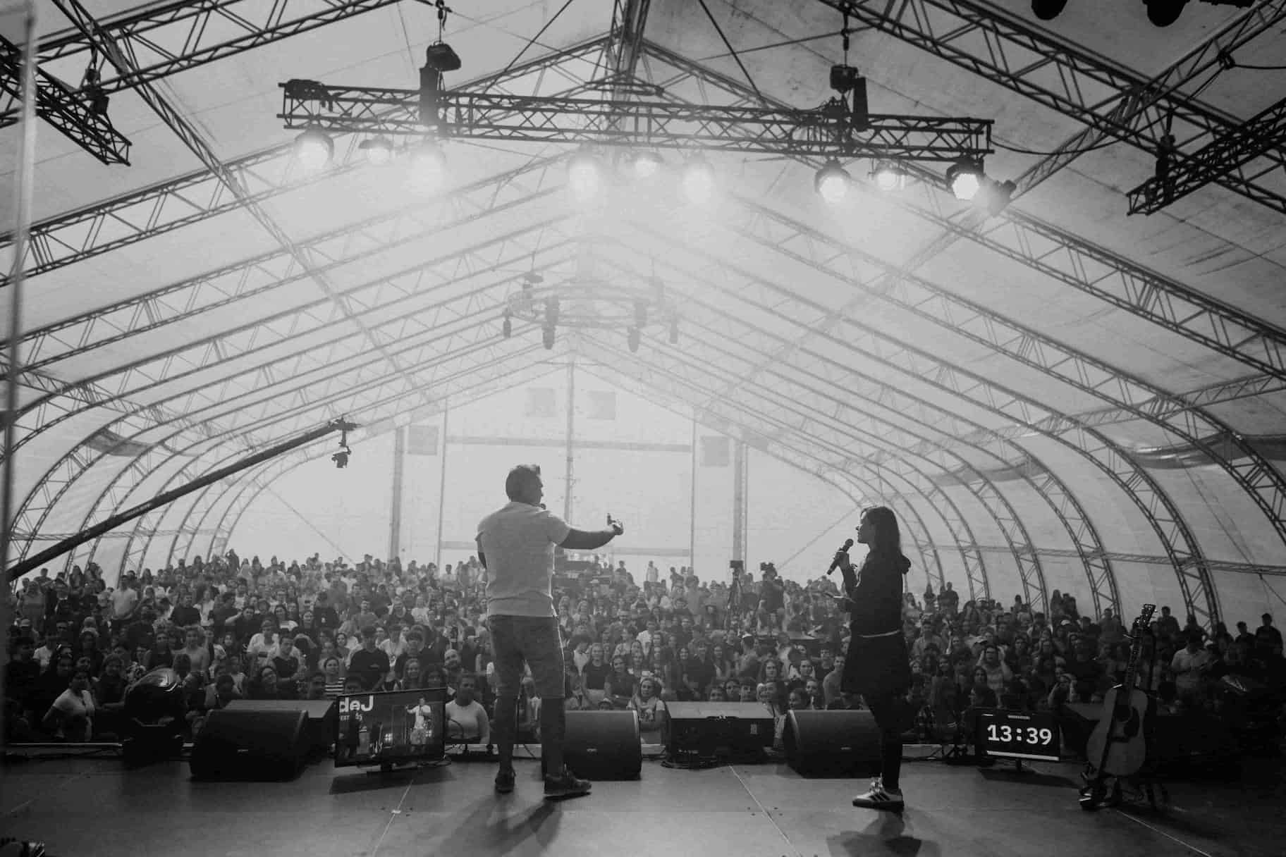 Singer crowd surfing at outdoor concert
