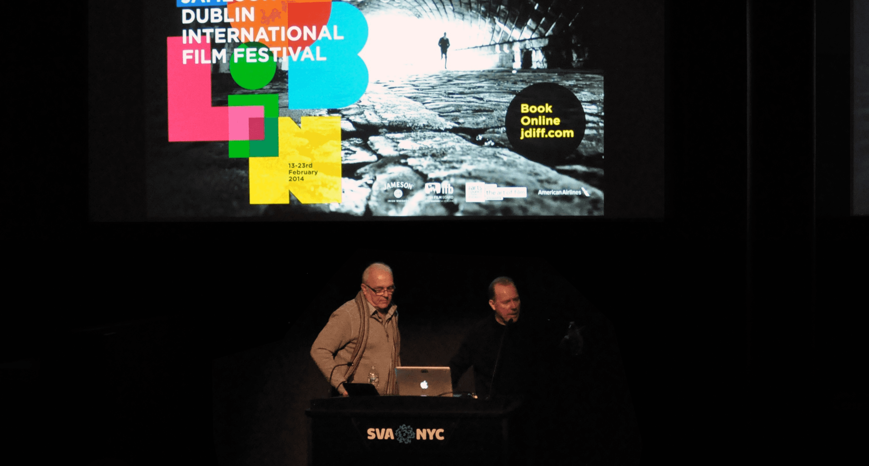 A photo of two people giving a lecture and showing some images on the screen projector behind them. Also there is the text Dublin International Film Festival.