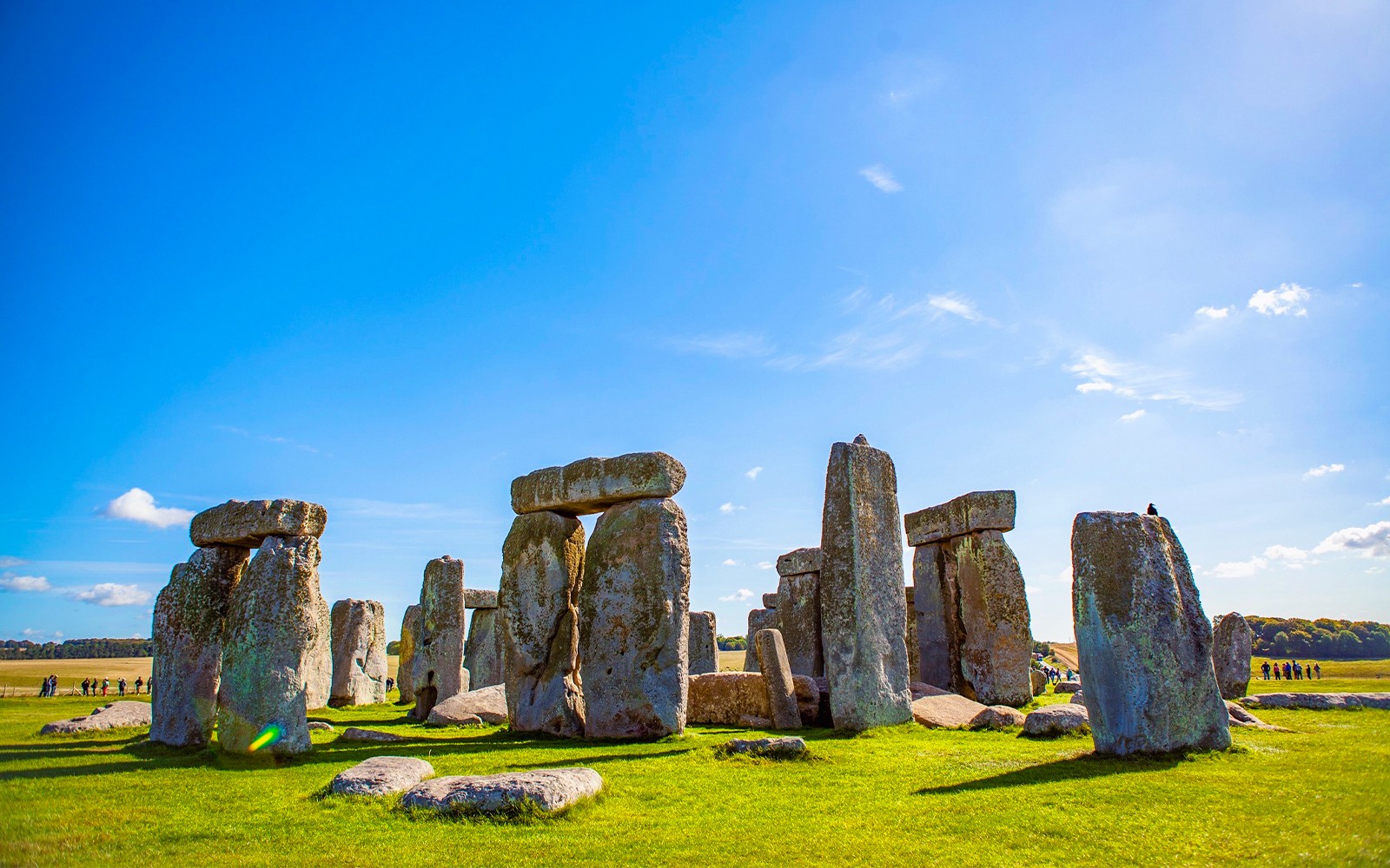 Stonehenge under a clear blue sky in Wiltshire, England.