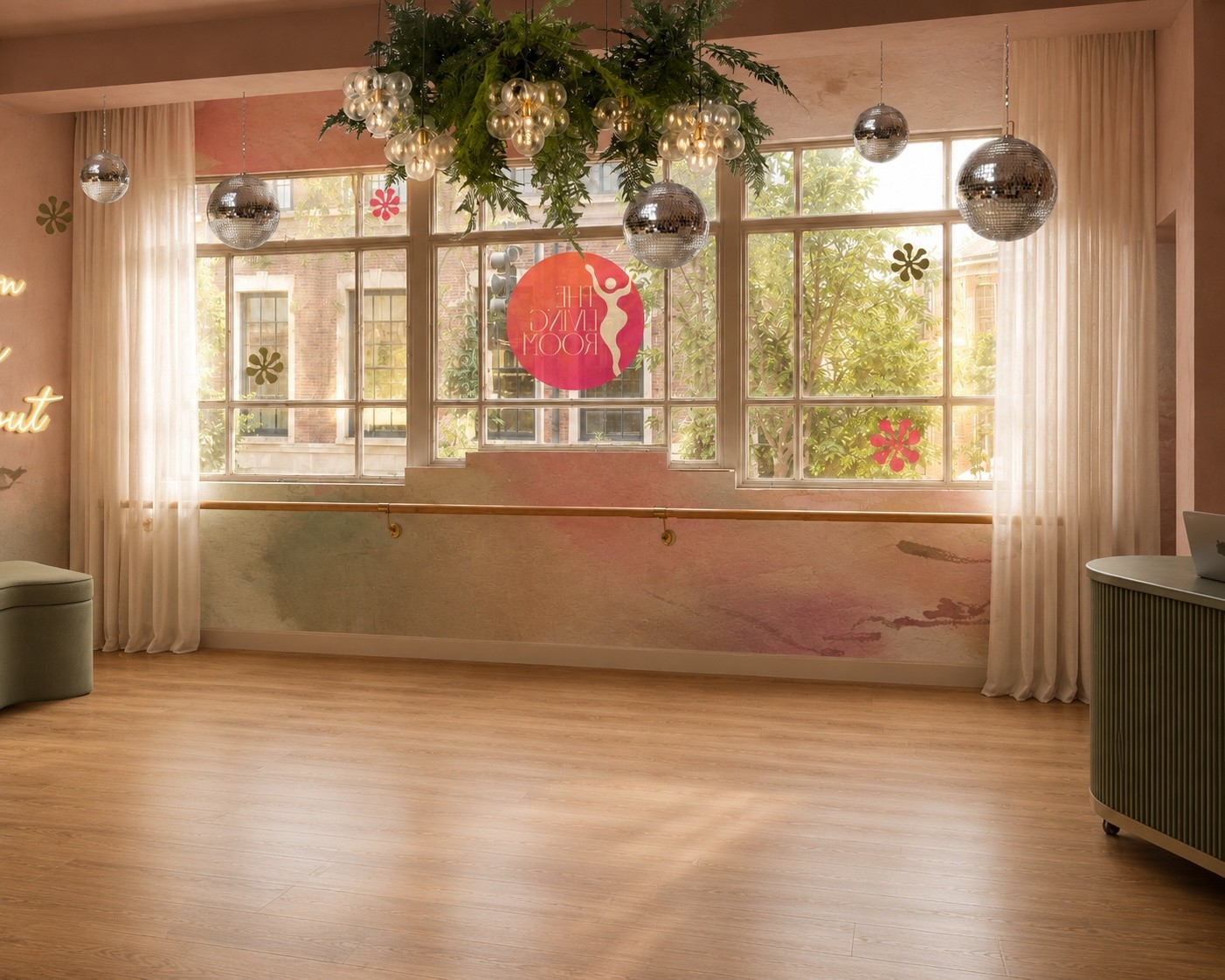 The Living Room studio interior with large windows, hanging disco balls, greenery and wooden flooring