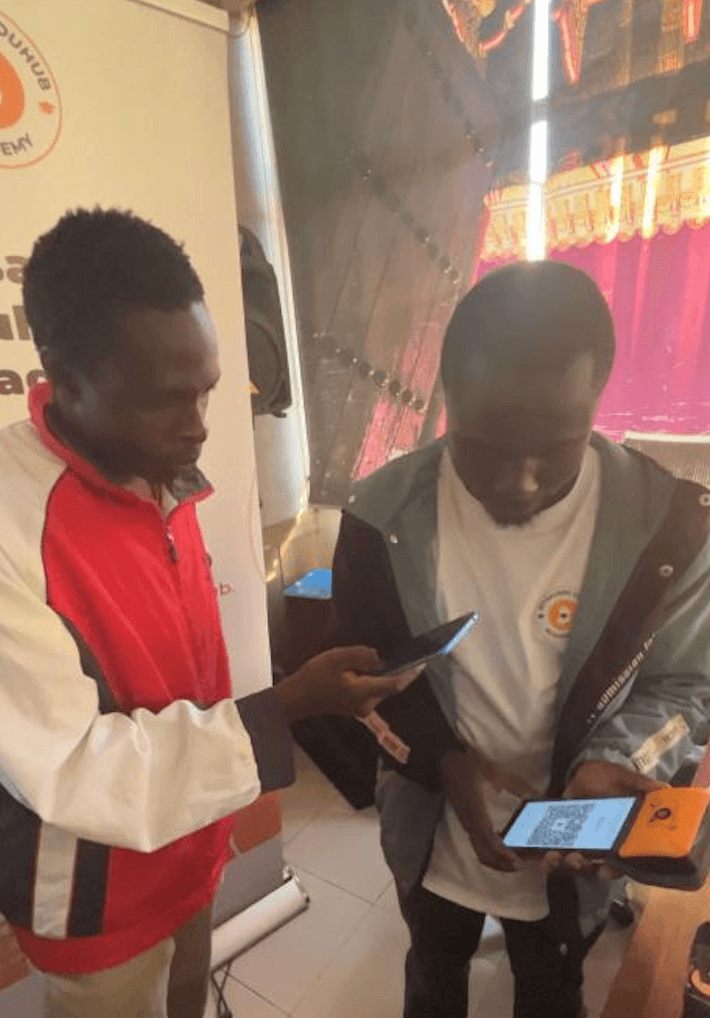 A Kenyatta University student pays another student in Bitcoin sats using the Fedi app during the April 2026 campus onboarding event in Nairobi