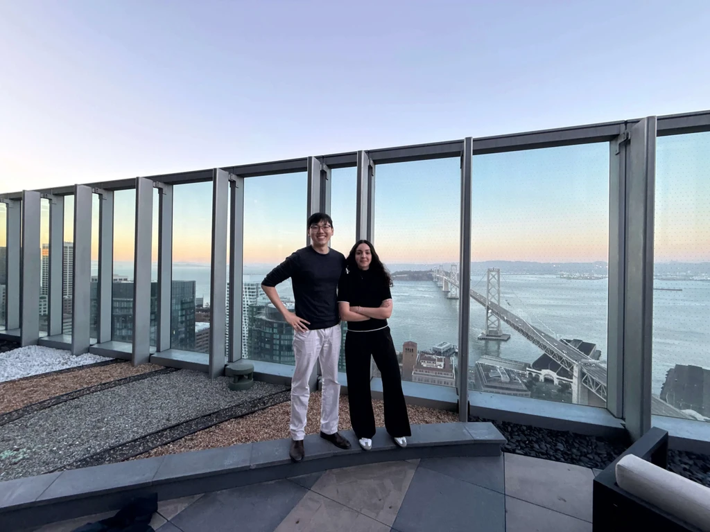the CEO and CTO on top of a building with the golden gate bridge in the background for an uncovr ai event
