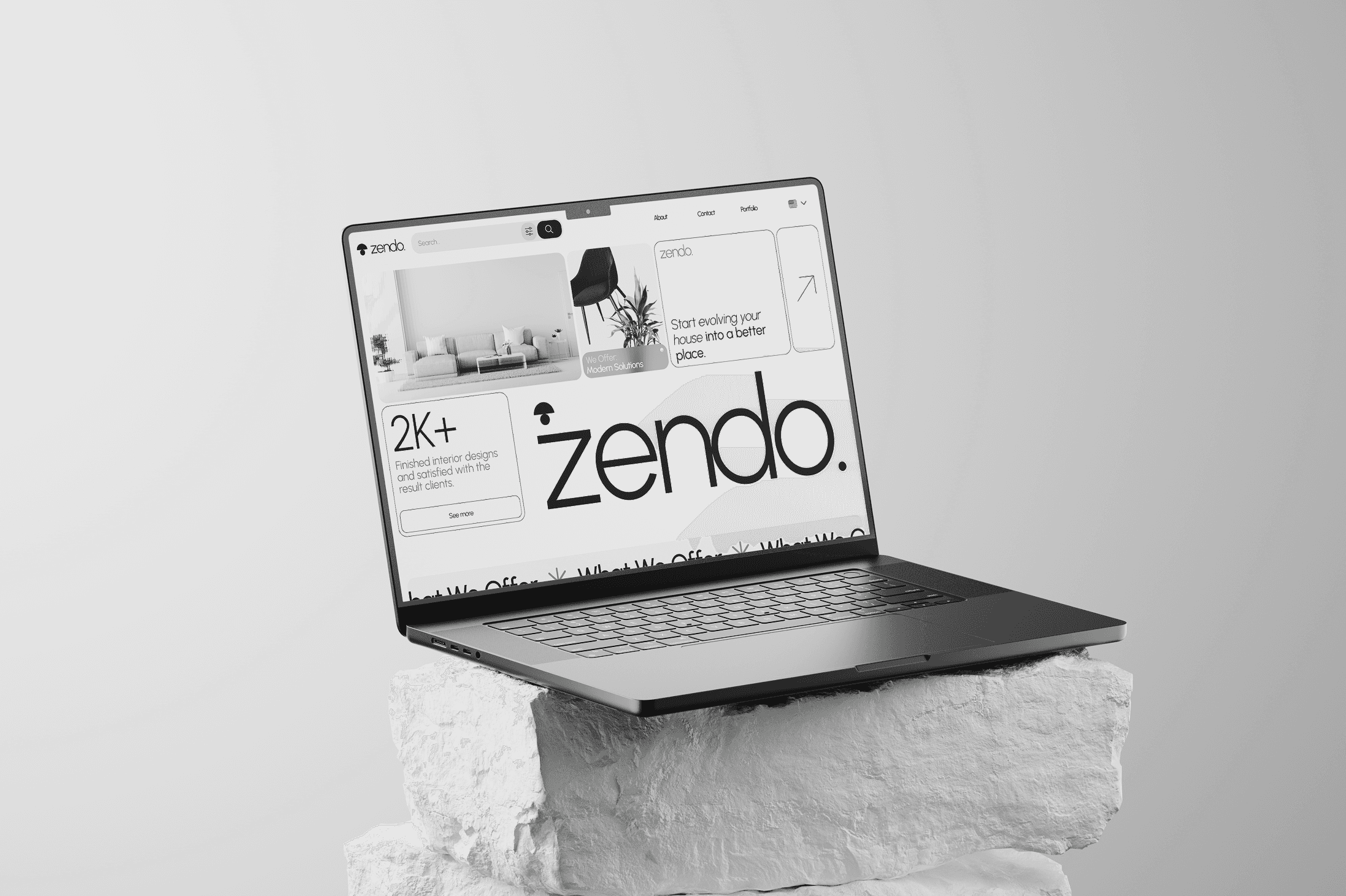 Laptop on a rock, website on screen