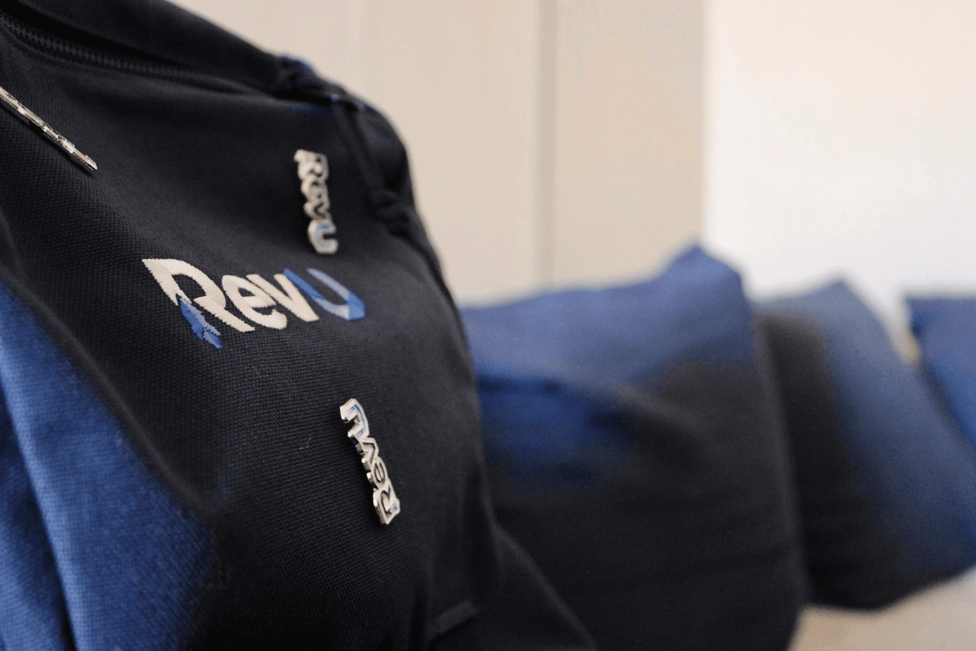 RevU branded bag and pins next to beanbags for offerwall users.