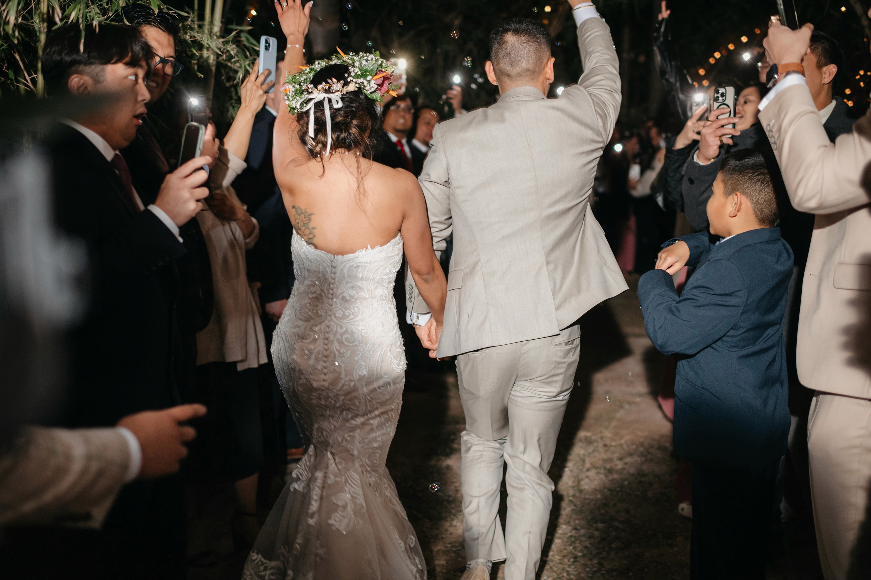 Night portrait of bride and groom grand exit with bubbles in the background