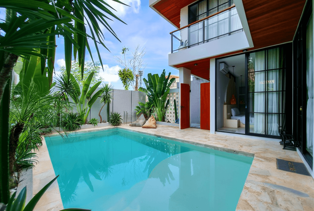 Modern open-plan living room with pool view in Pererenan. Expert real estate guidance for Bali villa investments.