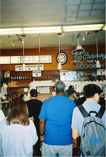 a flash photo of the line at katz delicatessen 