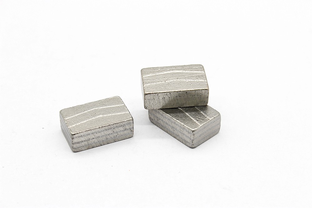 Three diamond segment for granite cutting, stacked on a white background tabletop