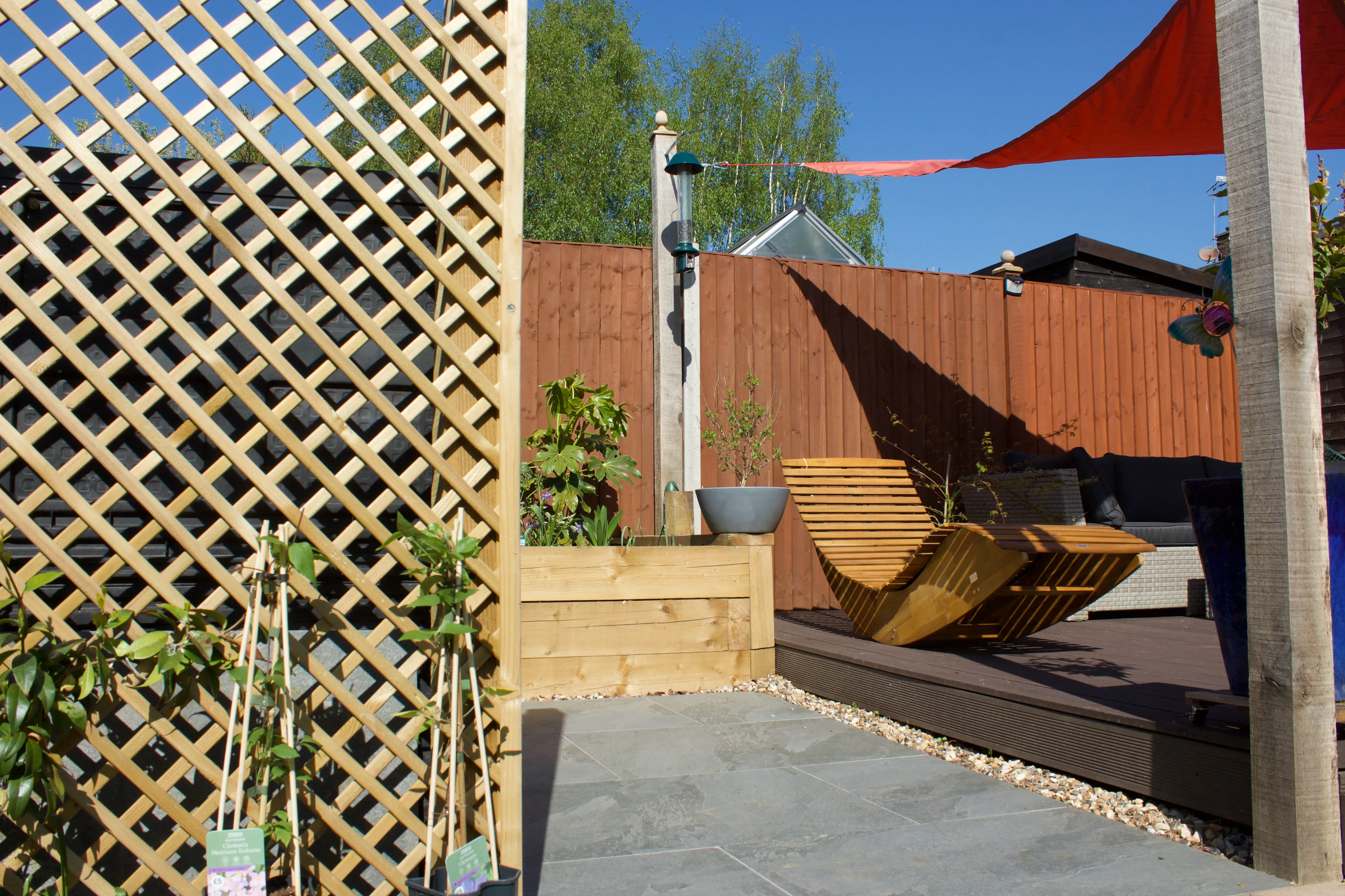 Lattice screen and colorful outdoor seating area, featuring a modern design and clear blue sky.