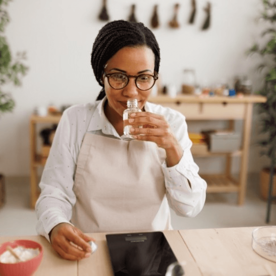 A woman working on cosmetic product creation.