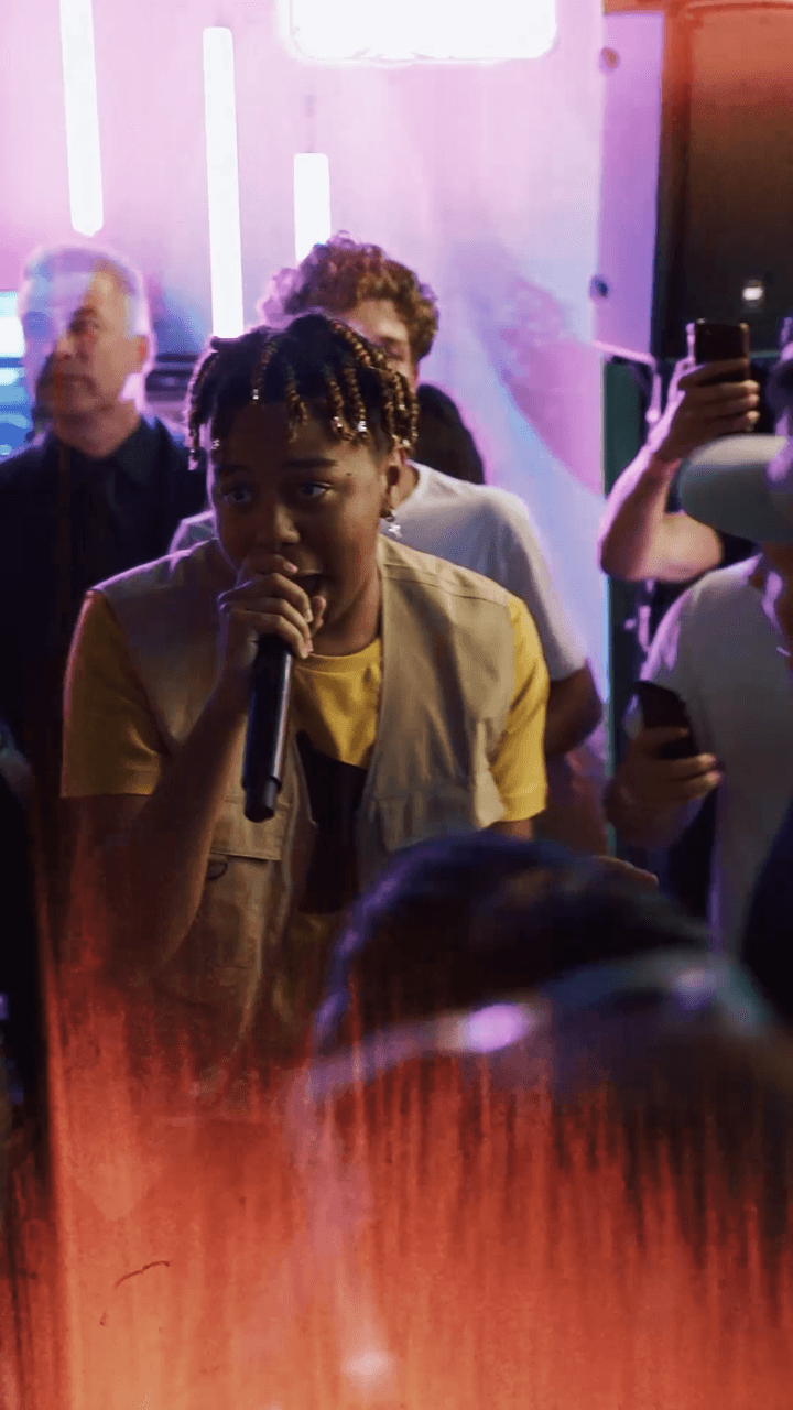 Cordae Perfoming and holding a mic