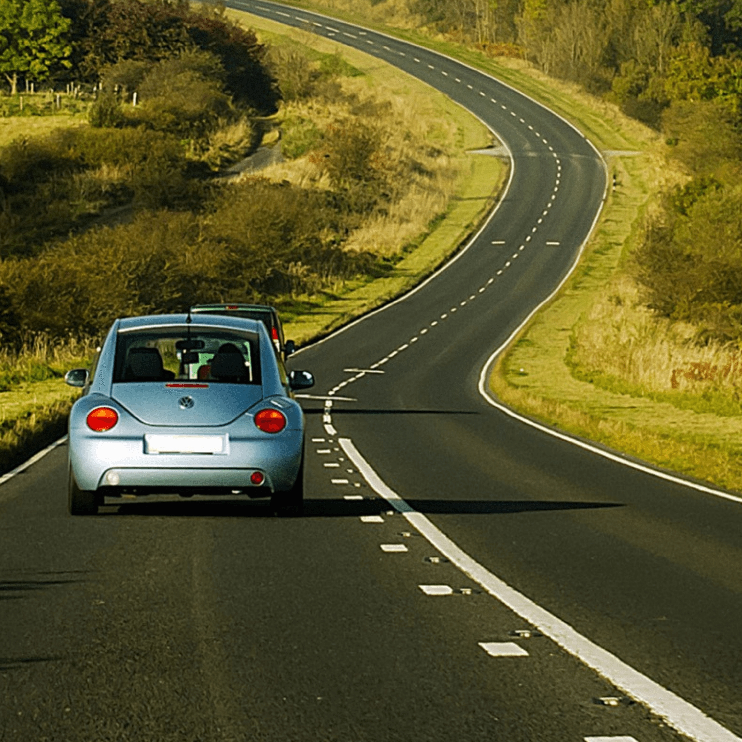 Car driving on a winding rural road in Ireland with its4women car insurance