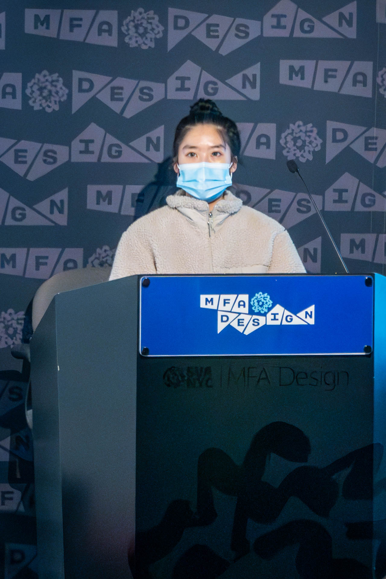 student at a podium giving a presentation